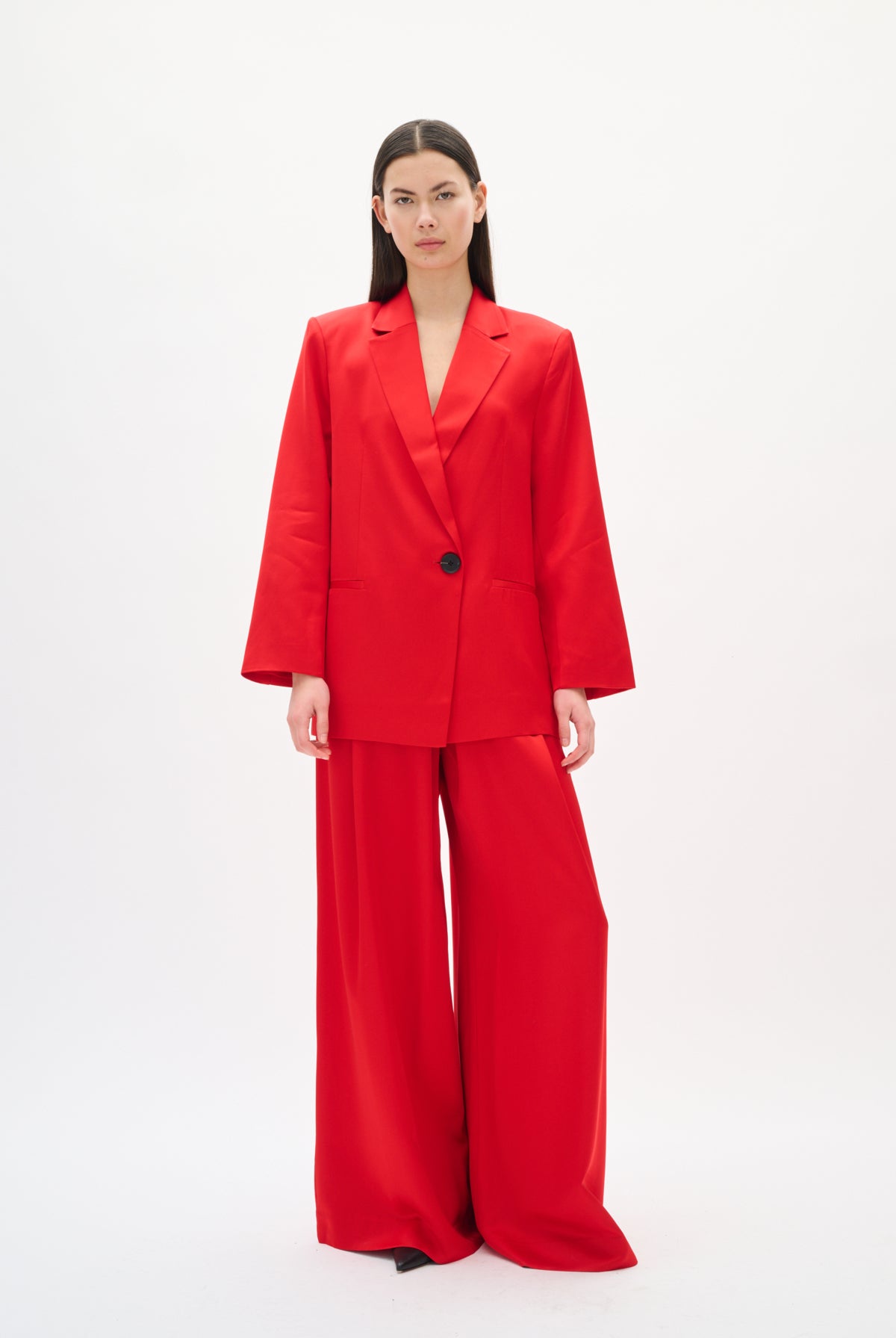 Woman wearing a red suit on a white background