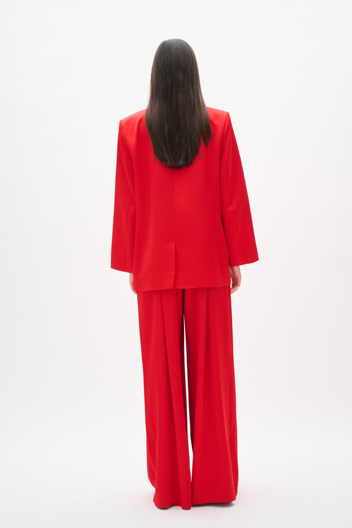 Person wearing a red outfit on a white background back angle