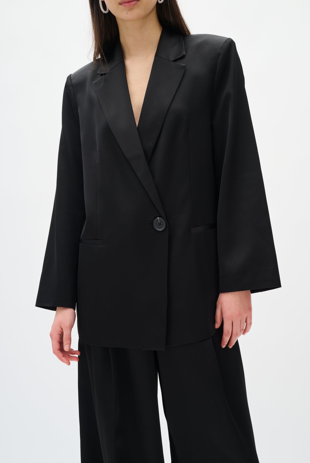 Person wearing a black suit on a white background