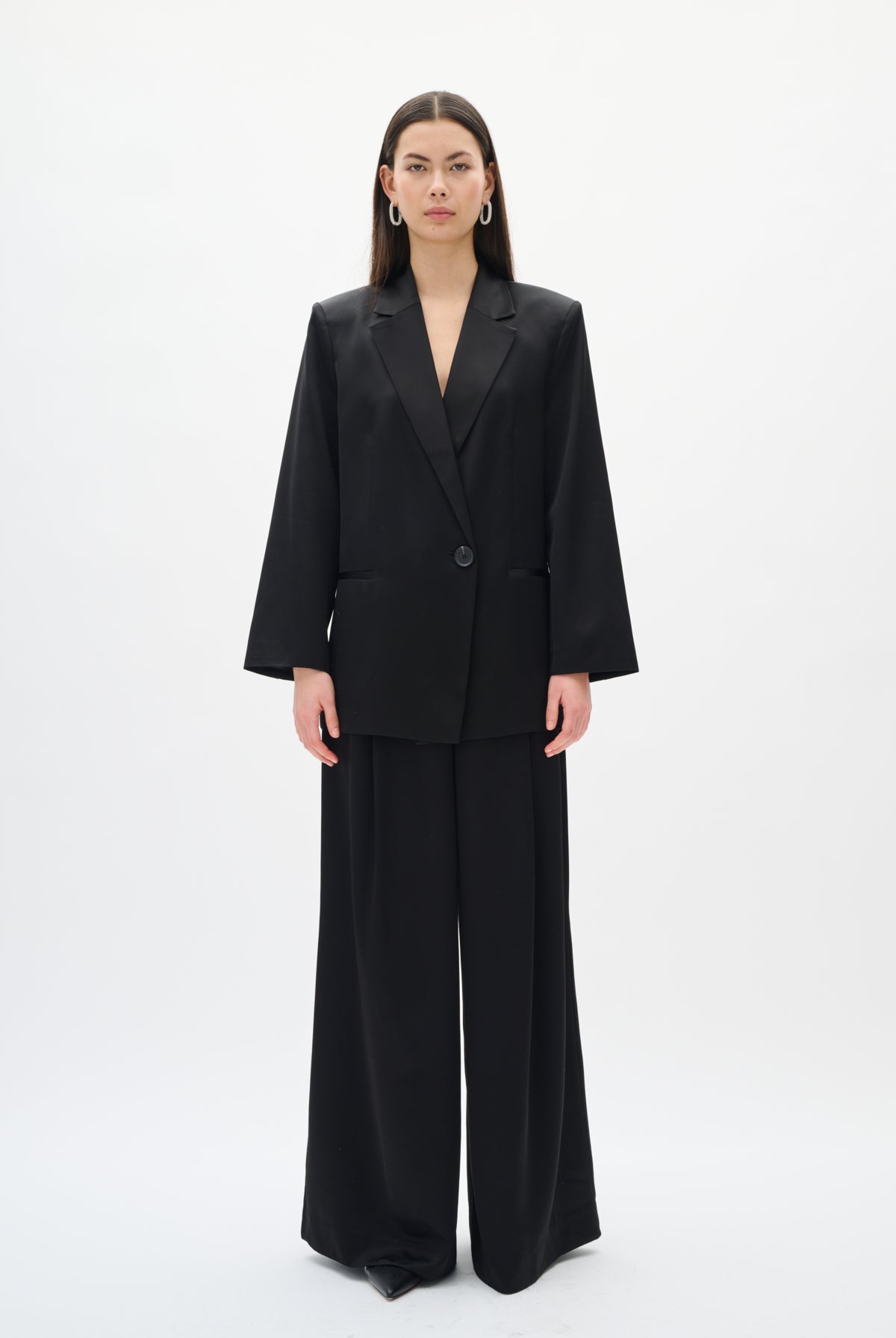 Person wearing a black suit on a white background