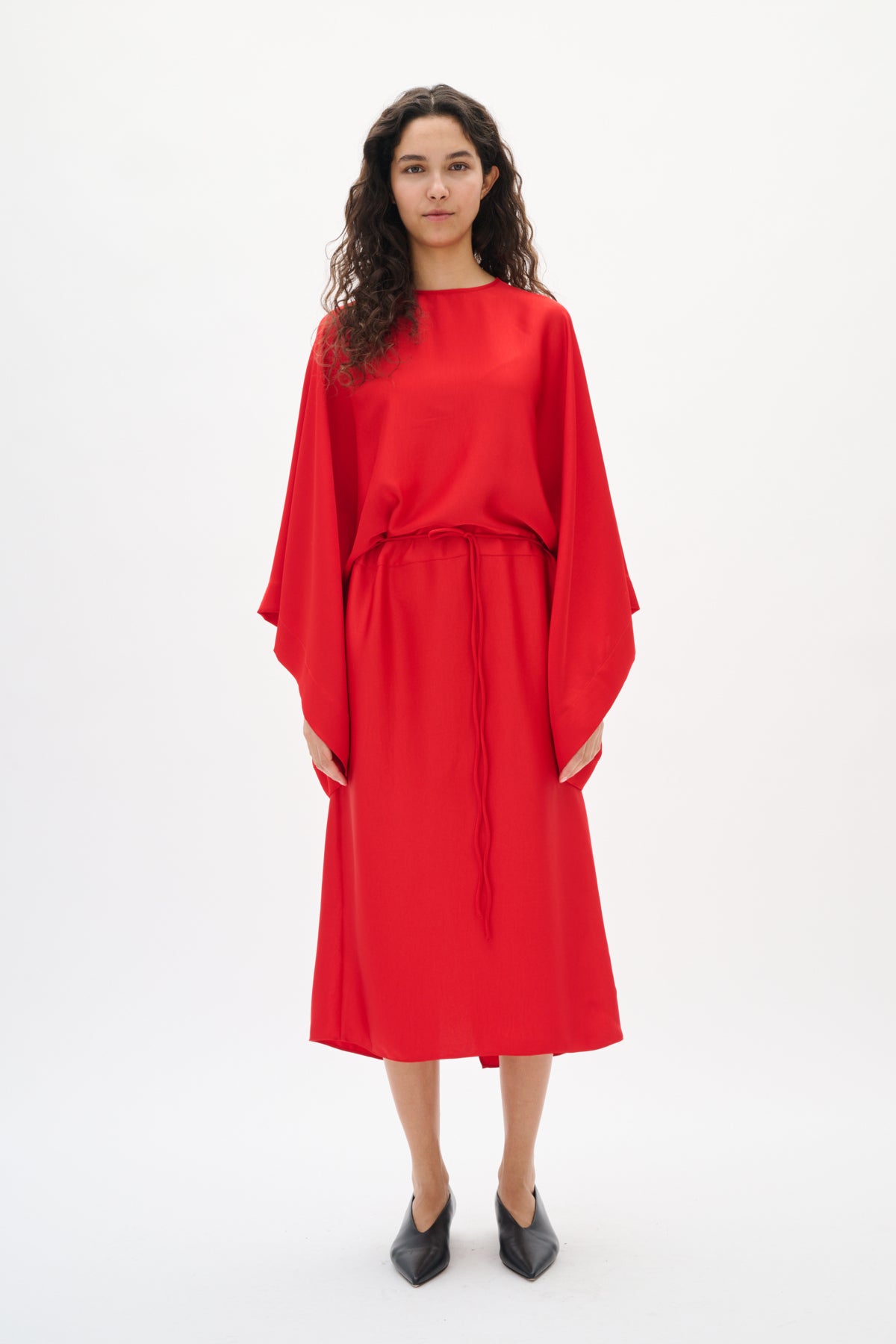 Woman wearing a red dress on a white background