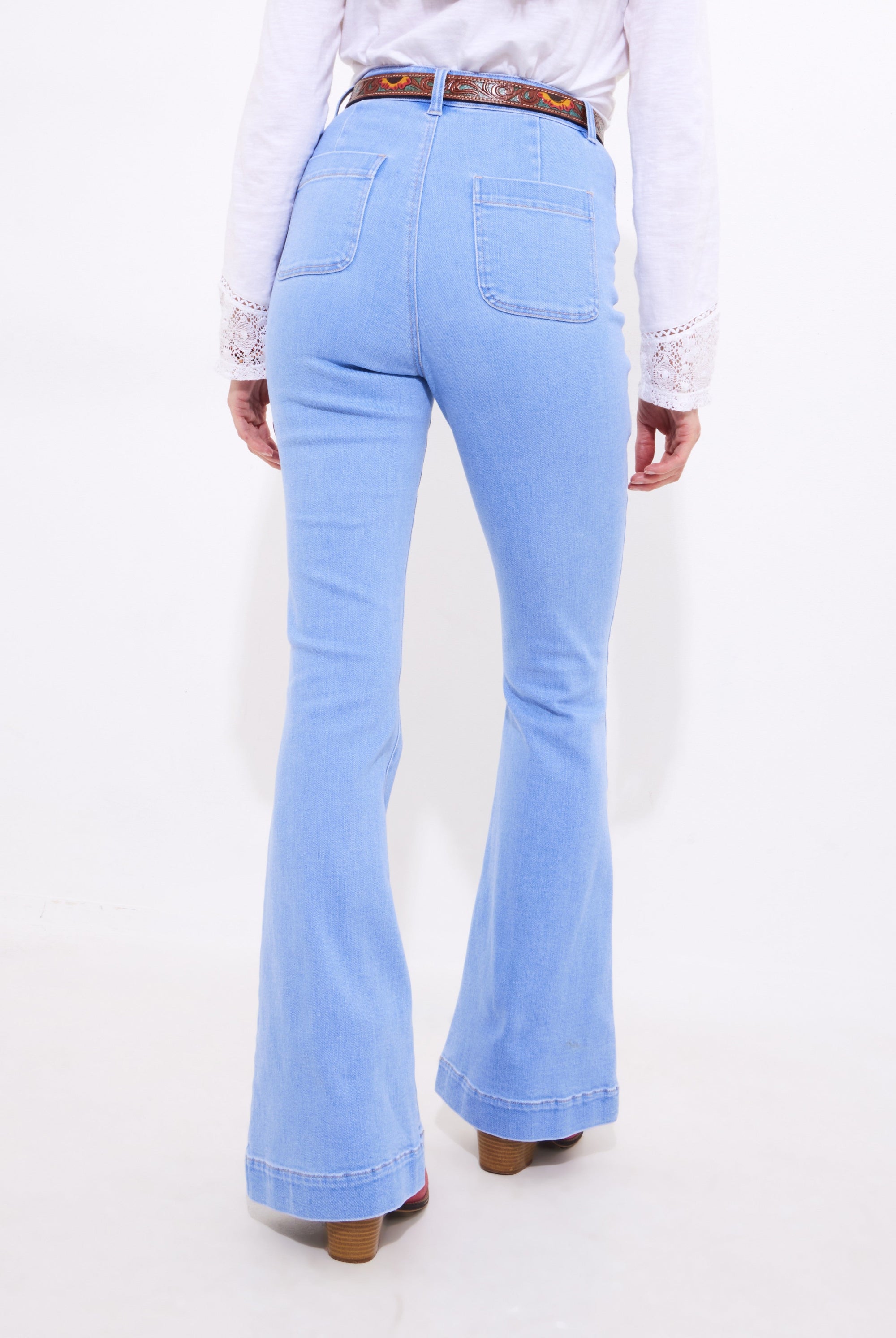 light wash denim flare jean worn by model back view