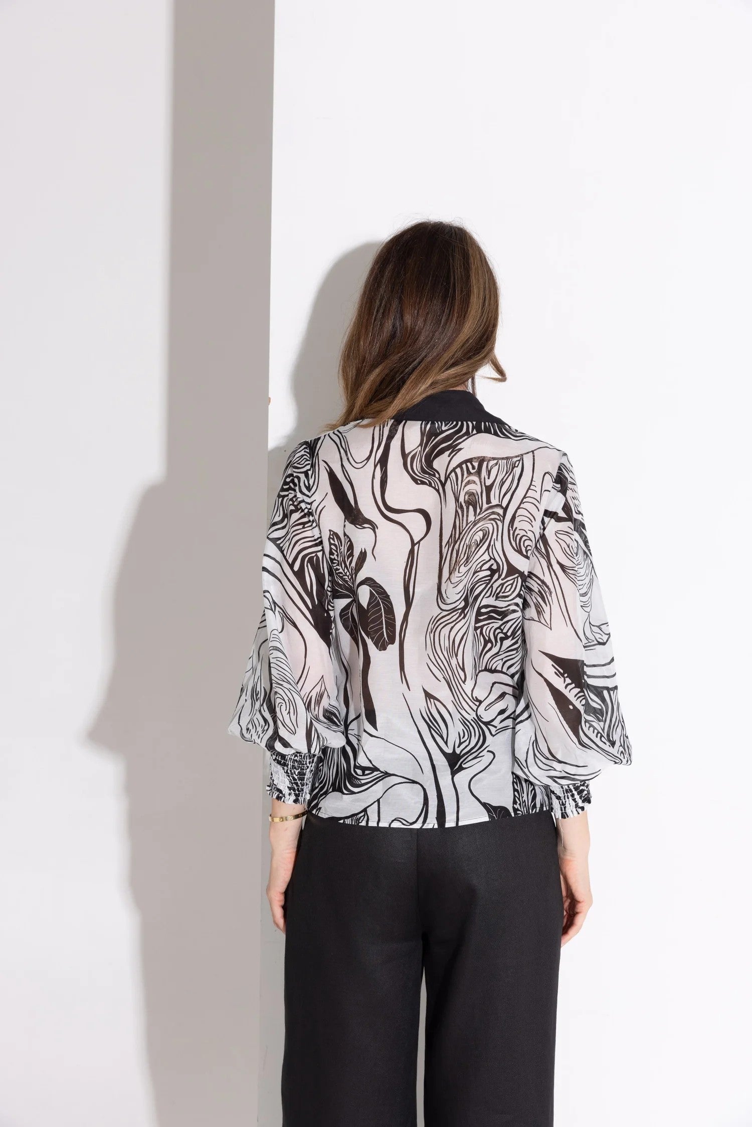womens blouse abstract floral black off white with black pants worn by model back view