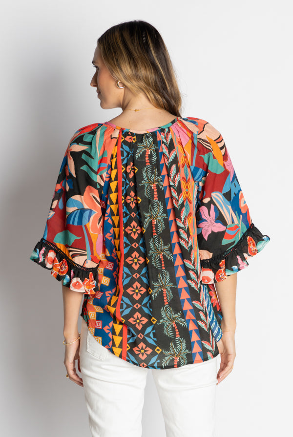 model wearing multi geometrical and floral print blouse back
