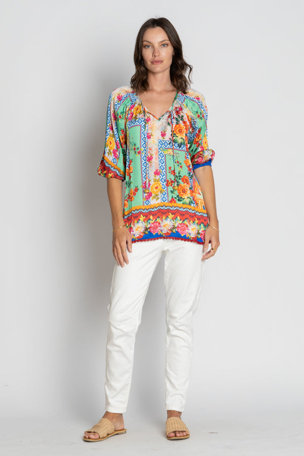 floral geometric multi colour blouse and white pants worn by model