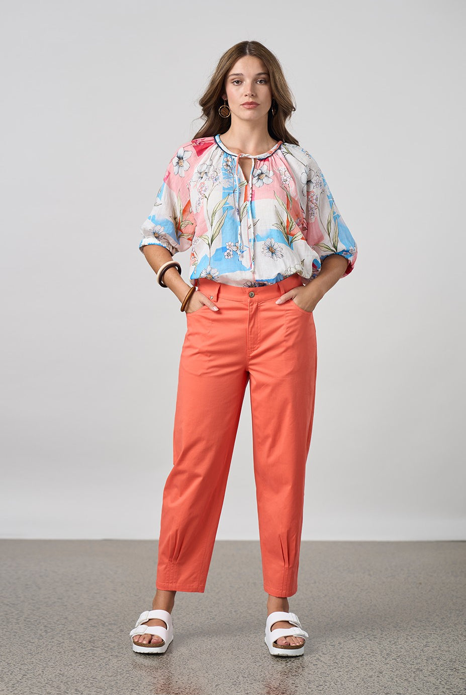 womens orange tulip pant and floral top worn by model