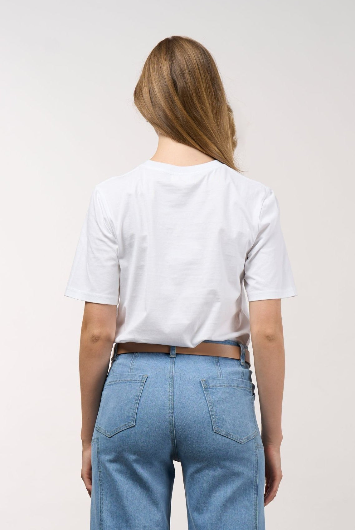 womens white tee with floral and grid line design worn by model back view