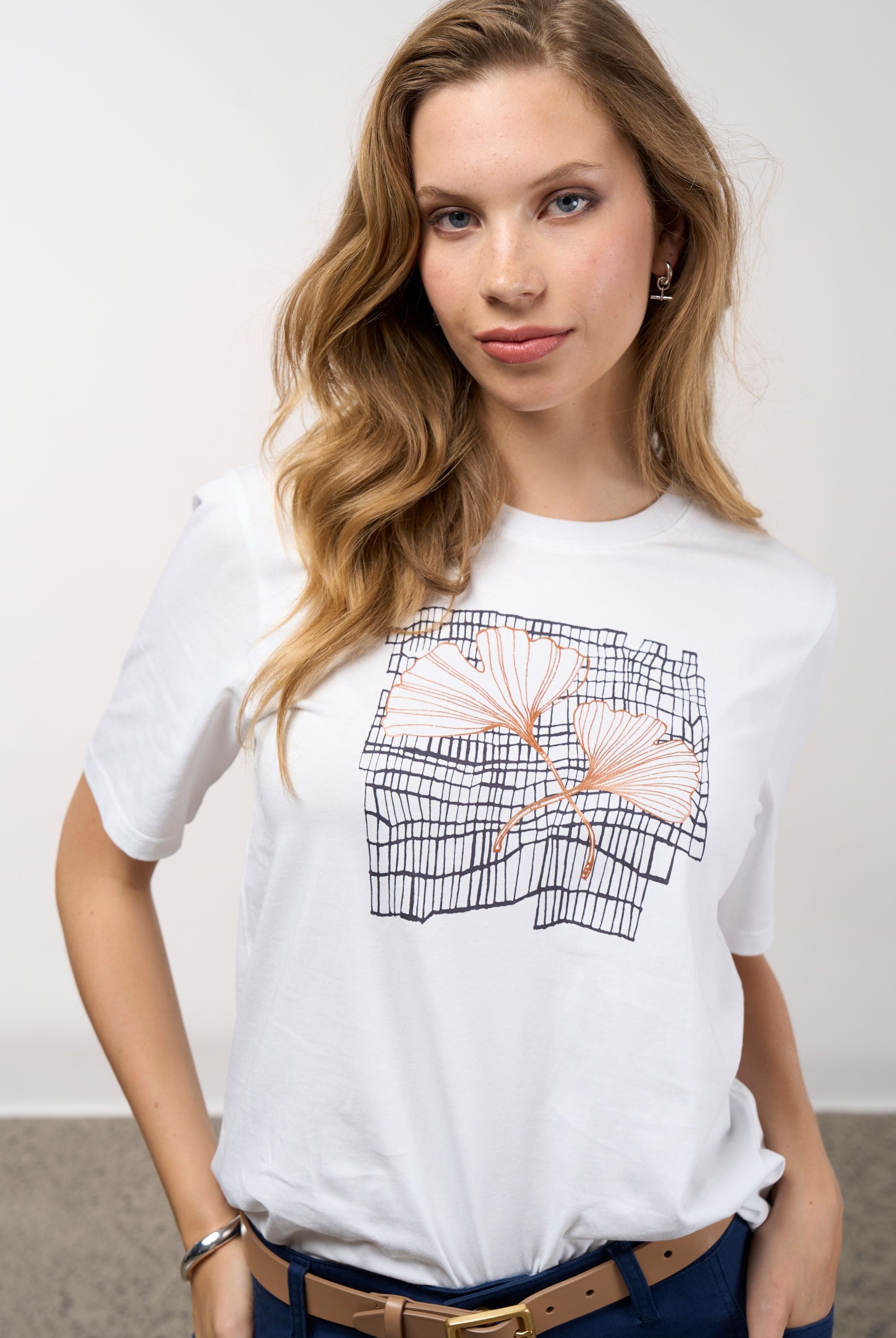 womens white tee with floral and grid line design worn by model