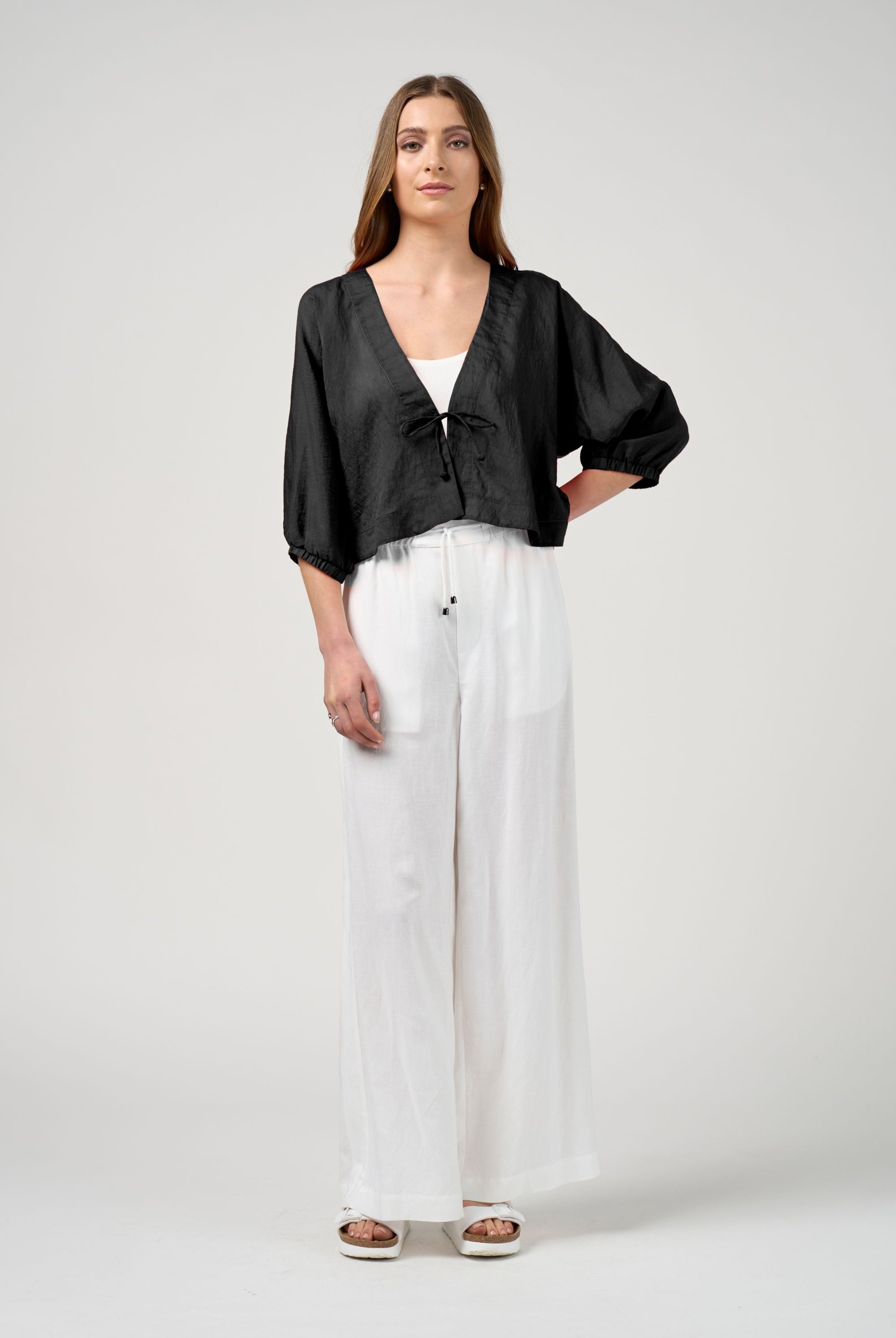 black tie jacket with white pant worn by model