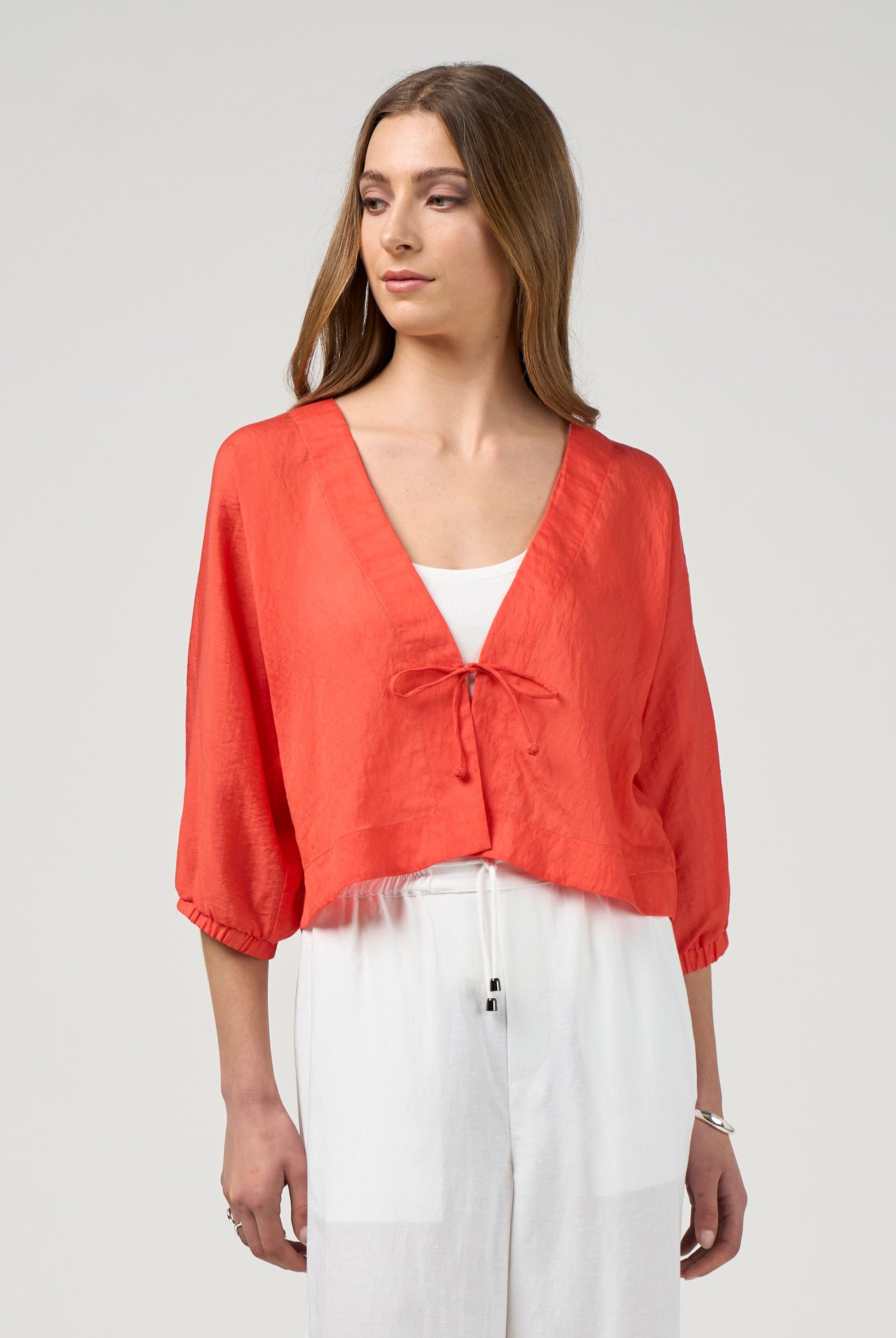 orange tie jacket with white pant worn by model