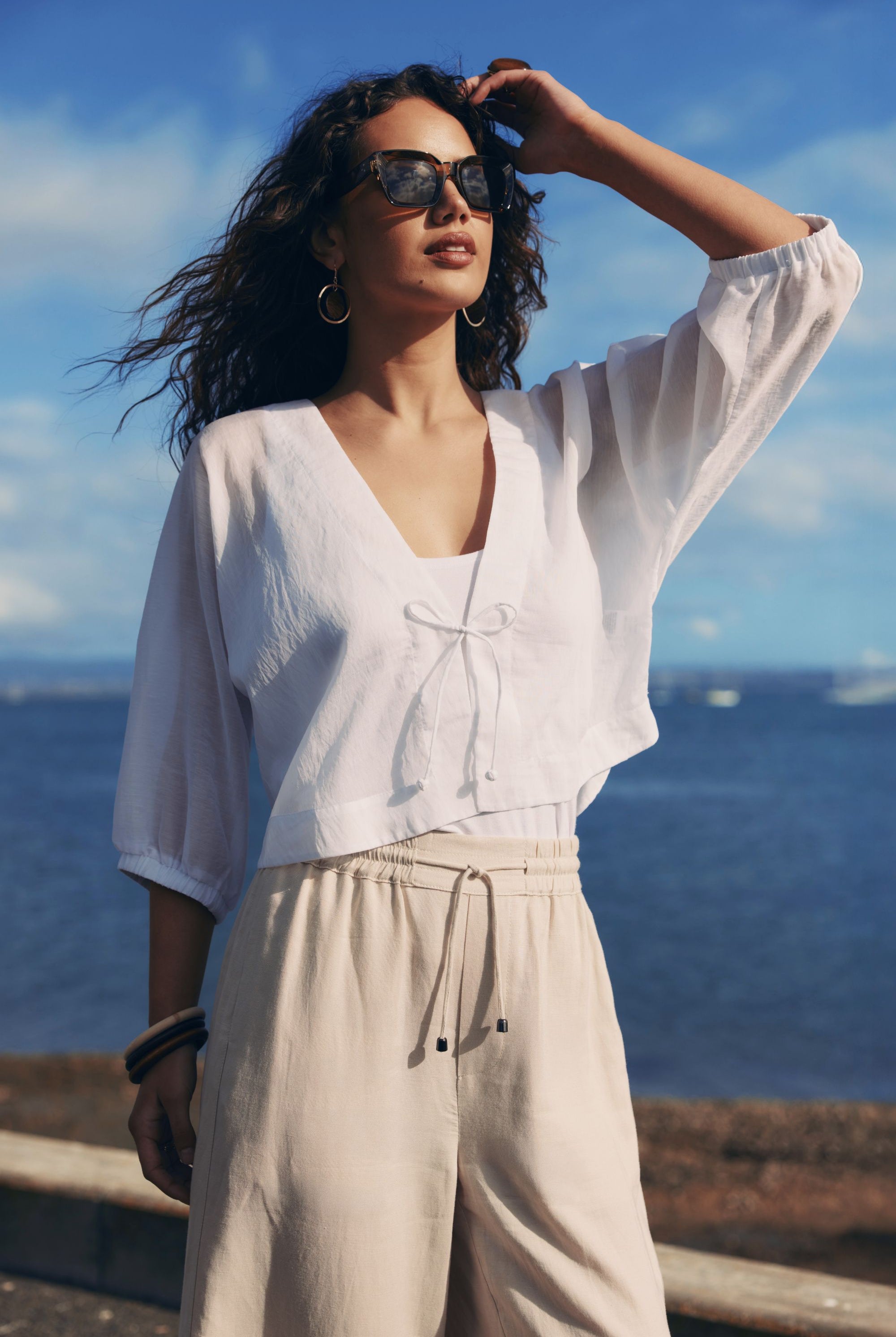 white tie jacket worn by model with ocean background