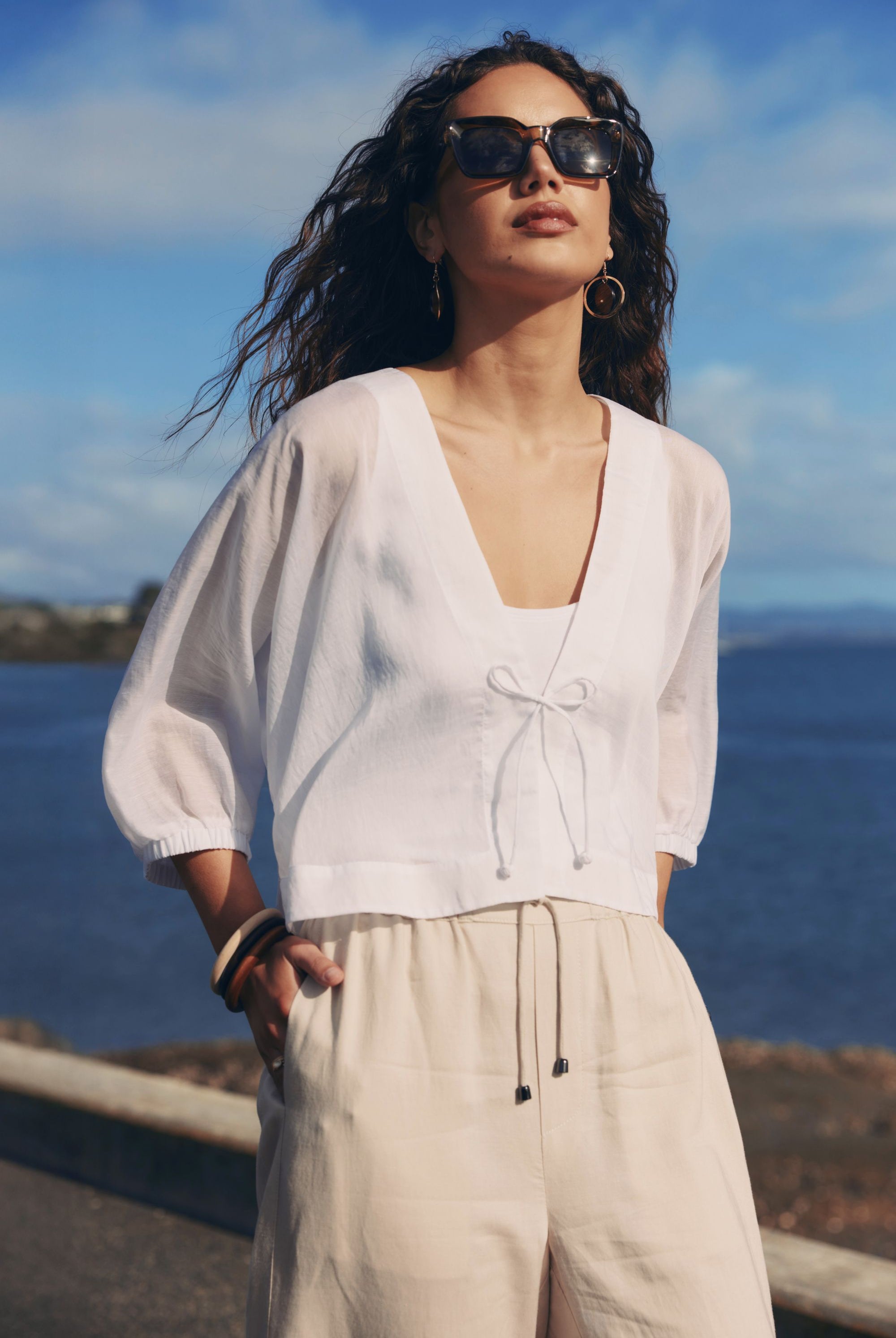 white tie jacket worn by model with ocean background