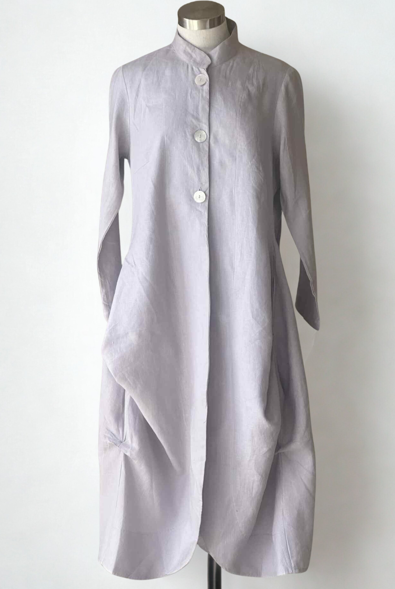 Long light gray dress on a mannequin against a white background