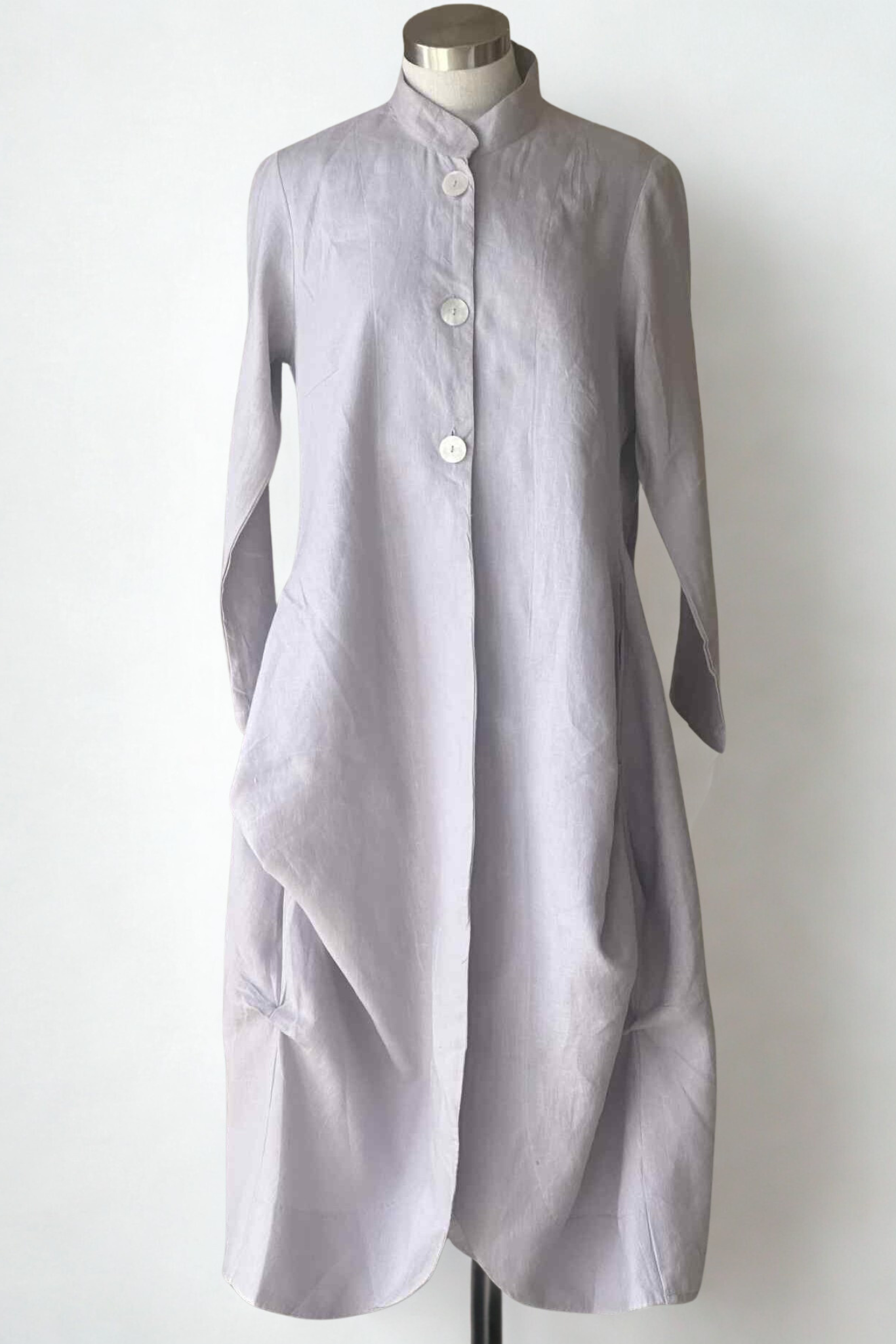 Long light gray dress on a mannequin against a white background