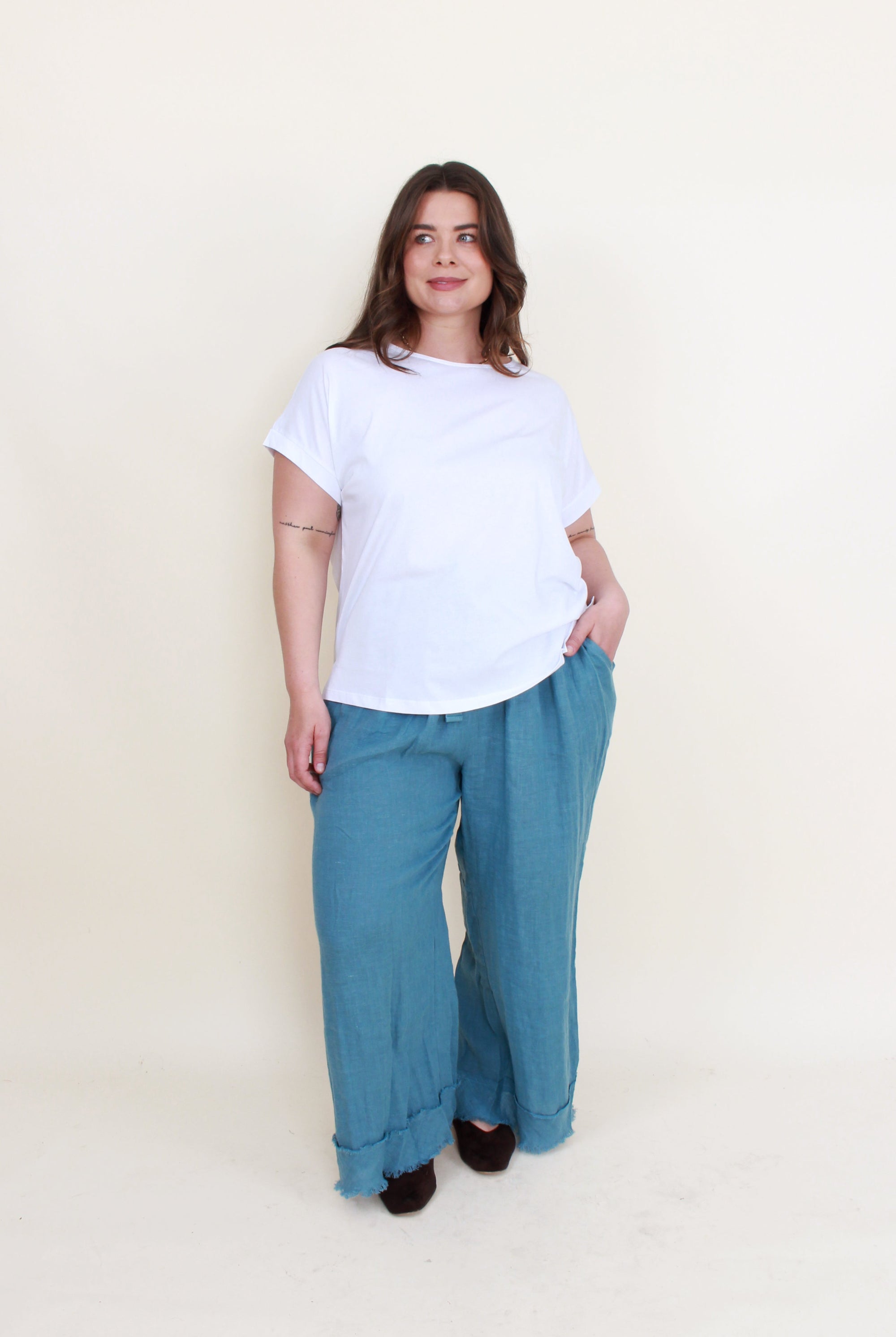 blue frey hem pants white top worn by model