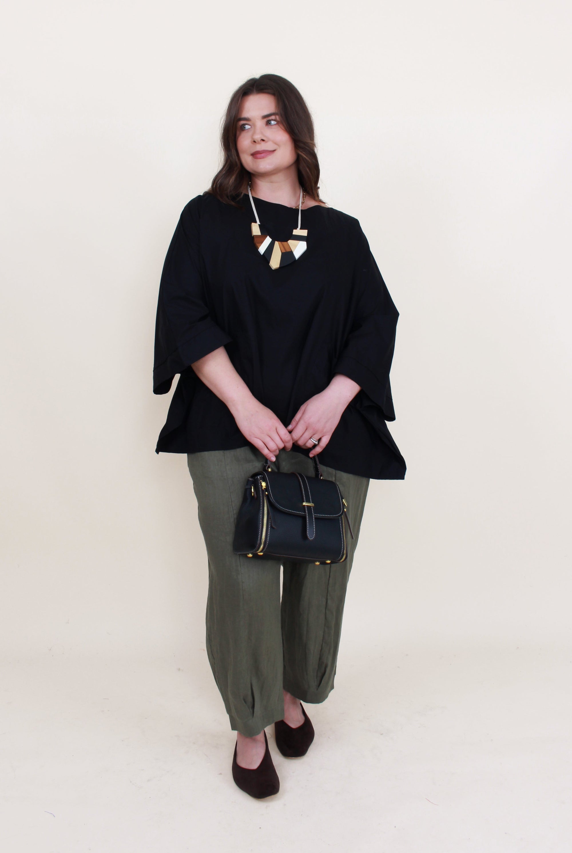 womens boxy patch pocket top in black with khaki pant worn by model