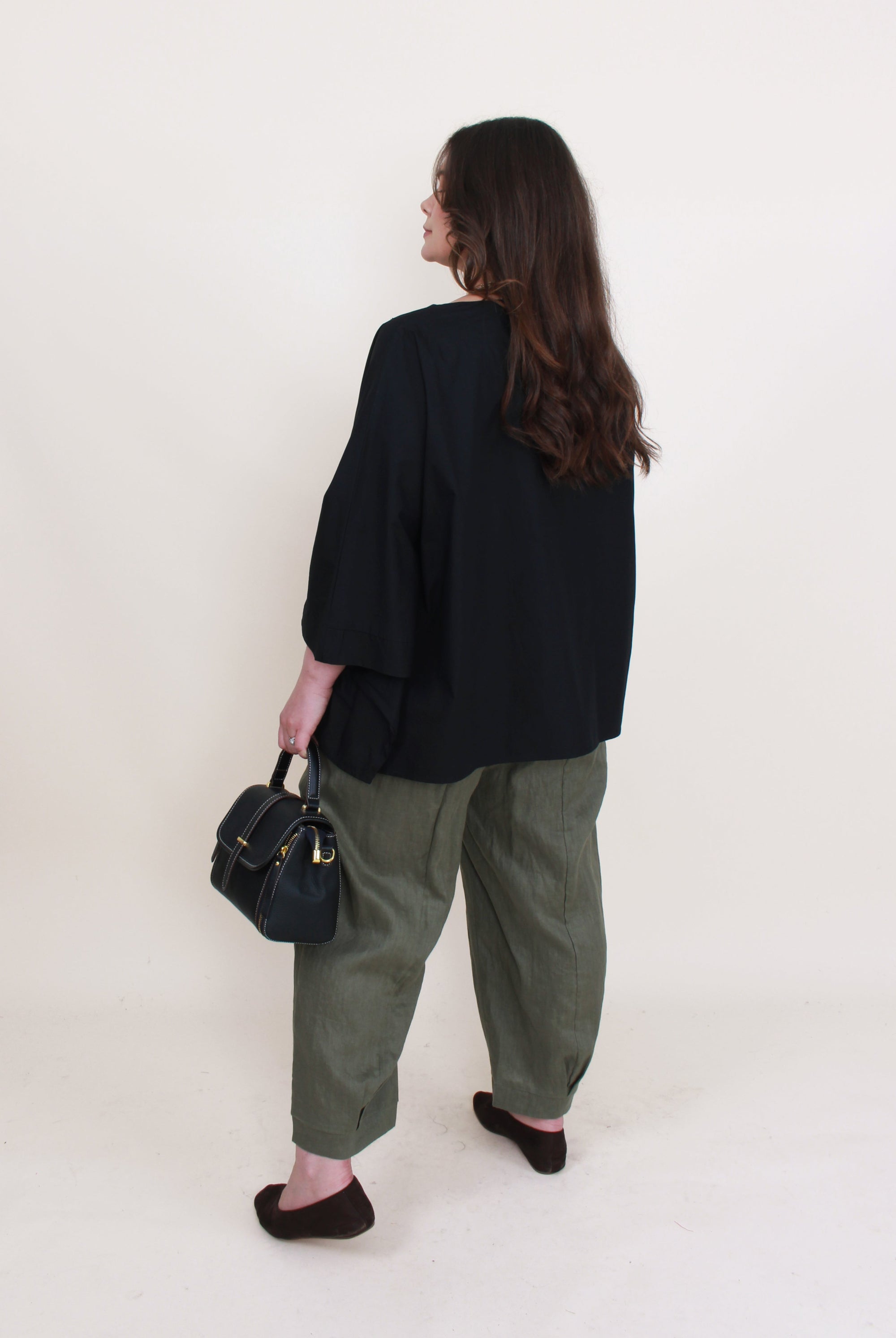 womens boxy patch pocket top in black with khaki pant worn by model back view