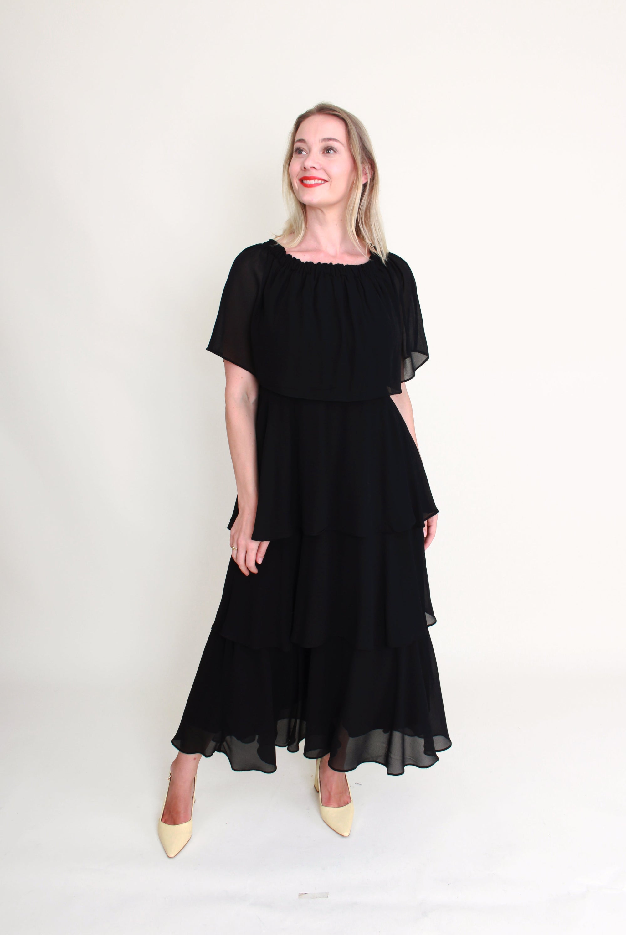 Woman wearing a black dress against a white background