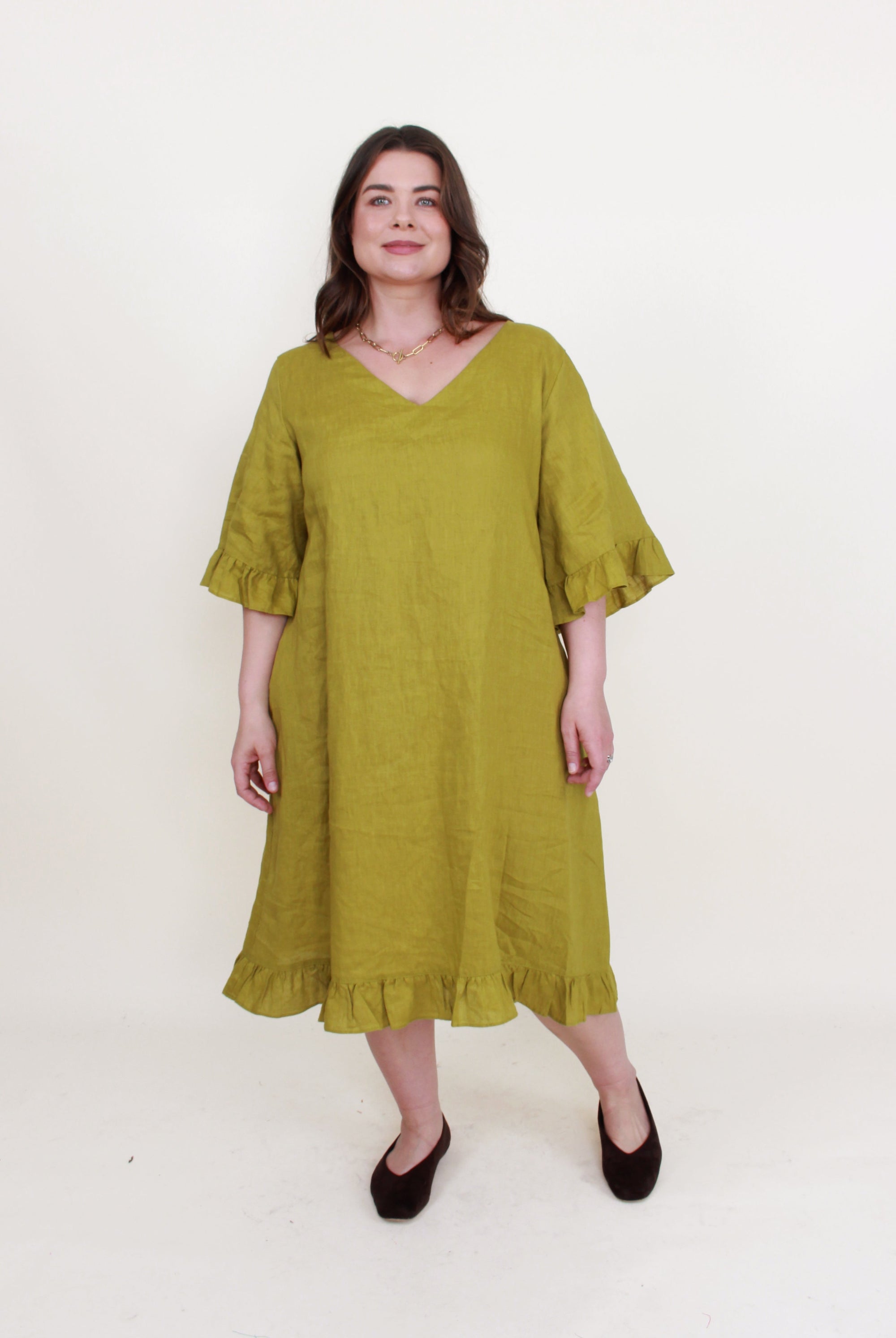avocado green ruffle hem linen midi dress worn by model