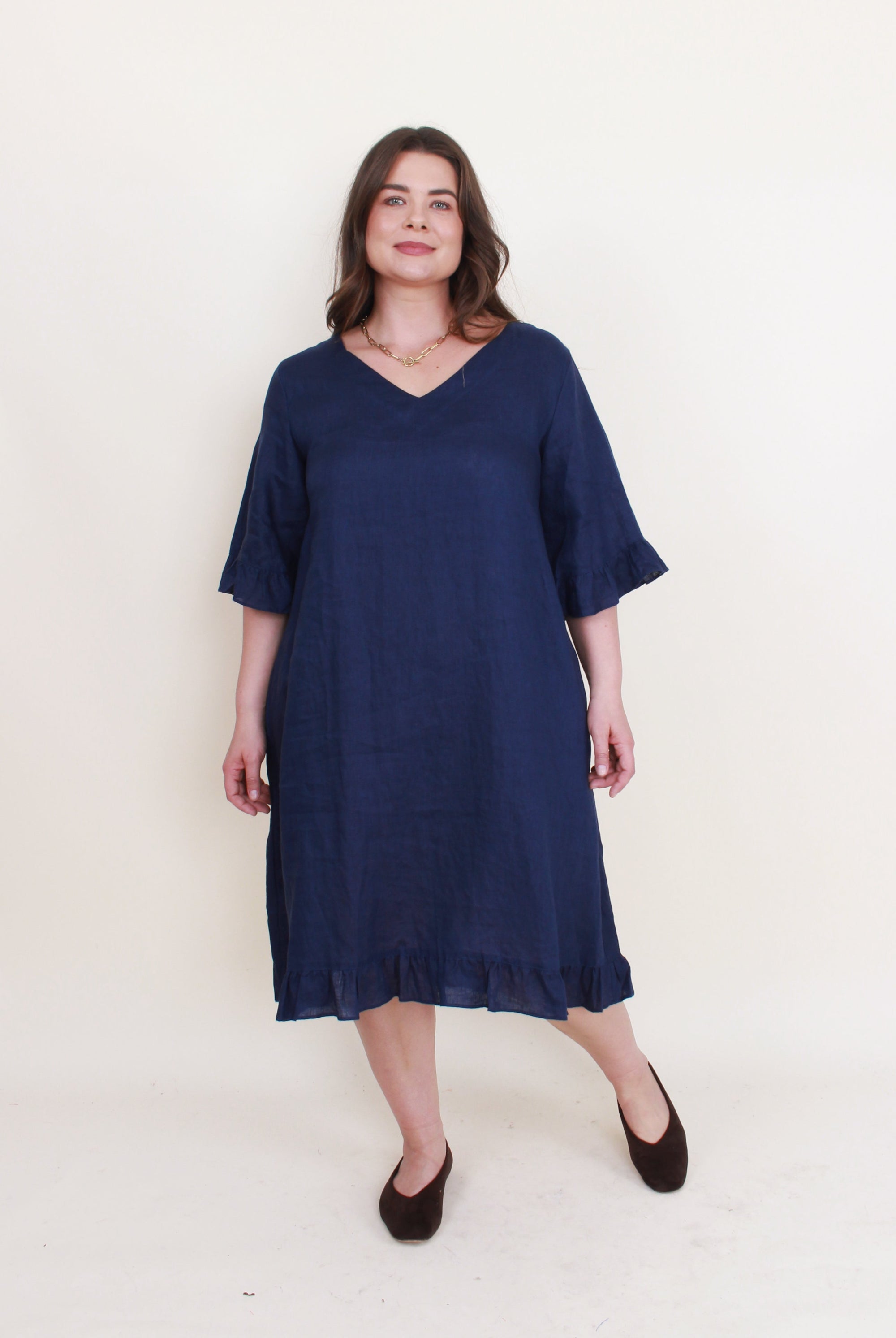 navy ruffle hem linen midi dress worn by model