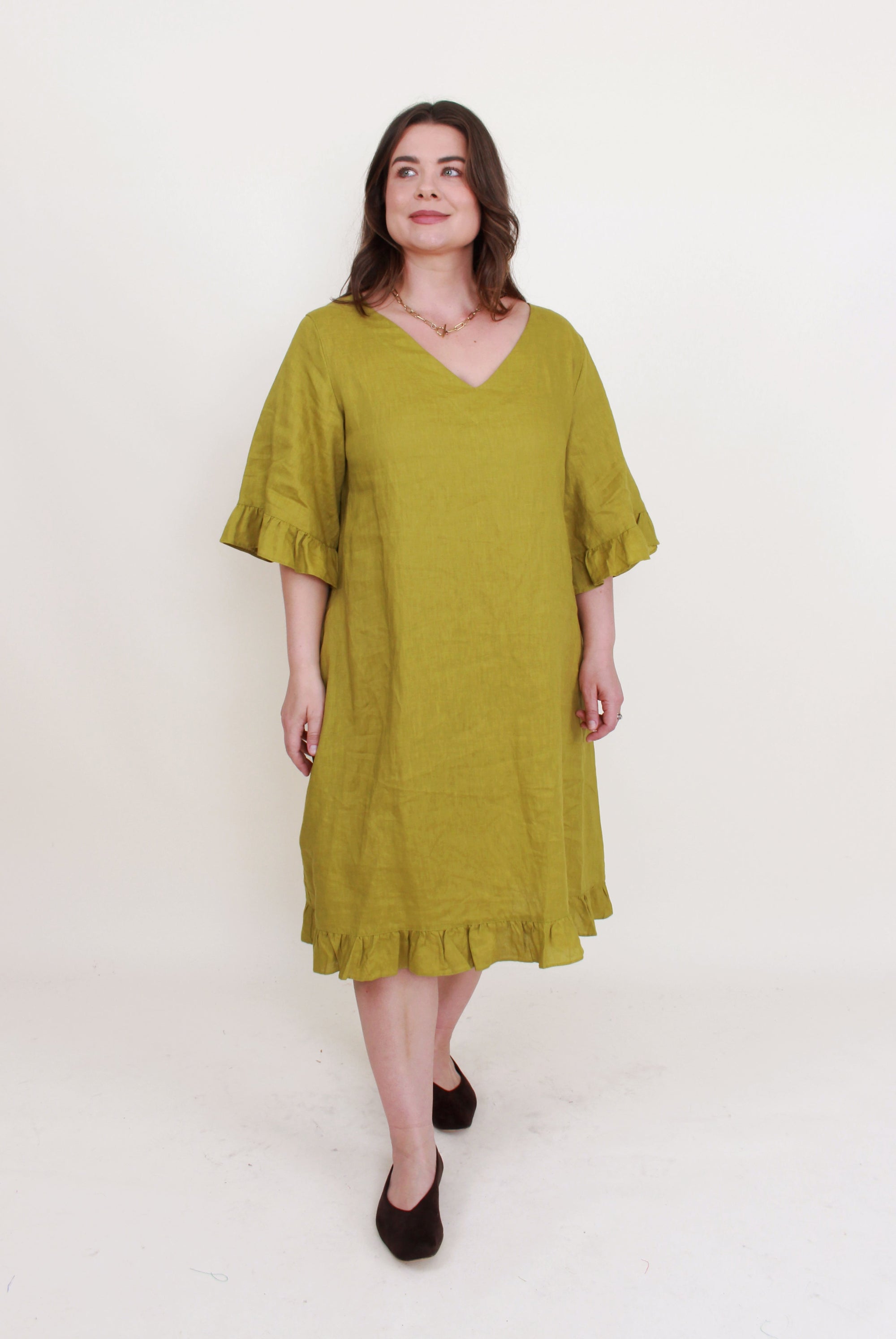 avocado green ruffle hem linen midi dress worn by model