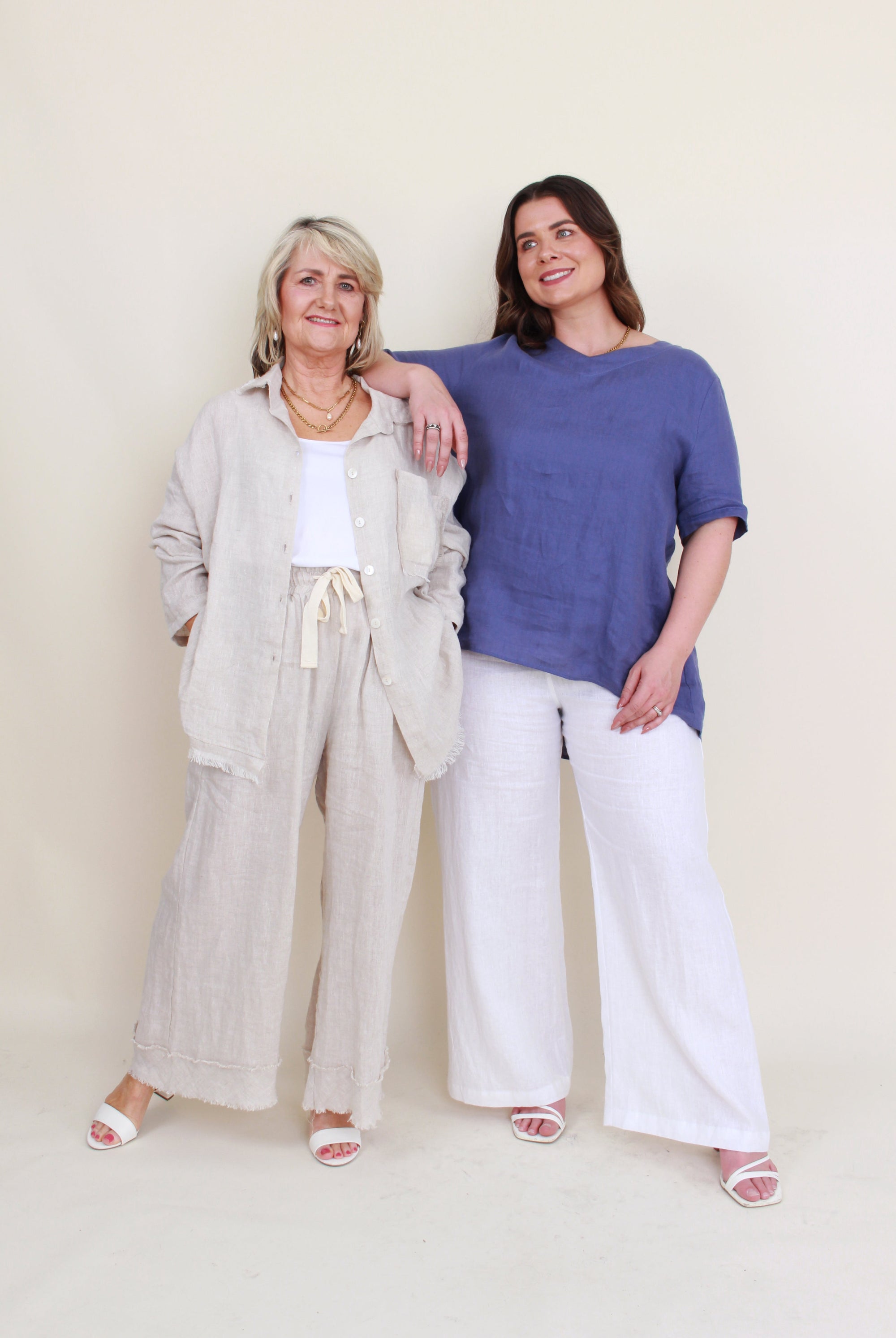 womens button through shirt with fray hems in sand and womens blue linen top worn by second model