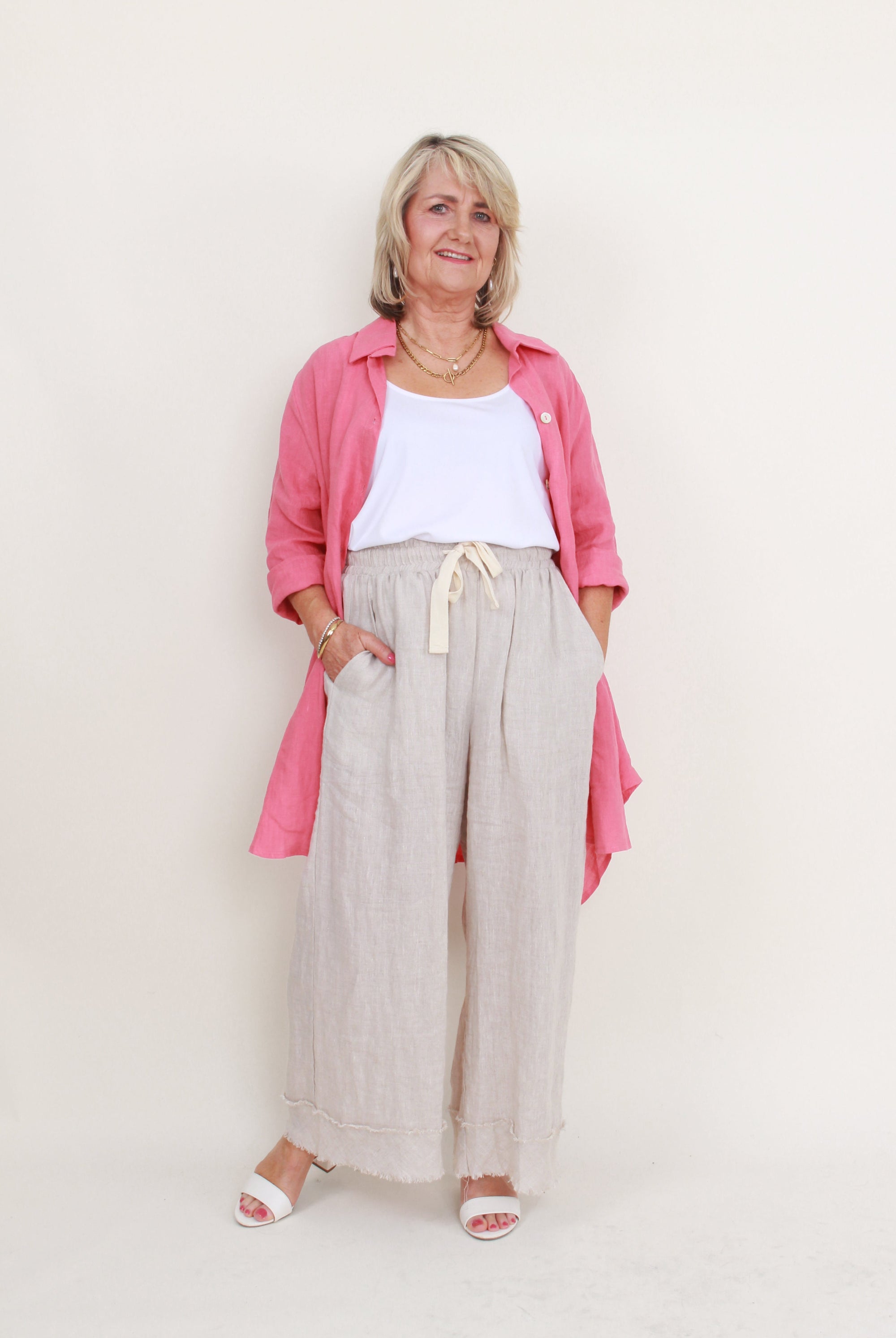 womens high low swing button through top in melon worn by model unbuttoned