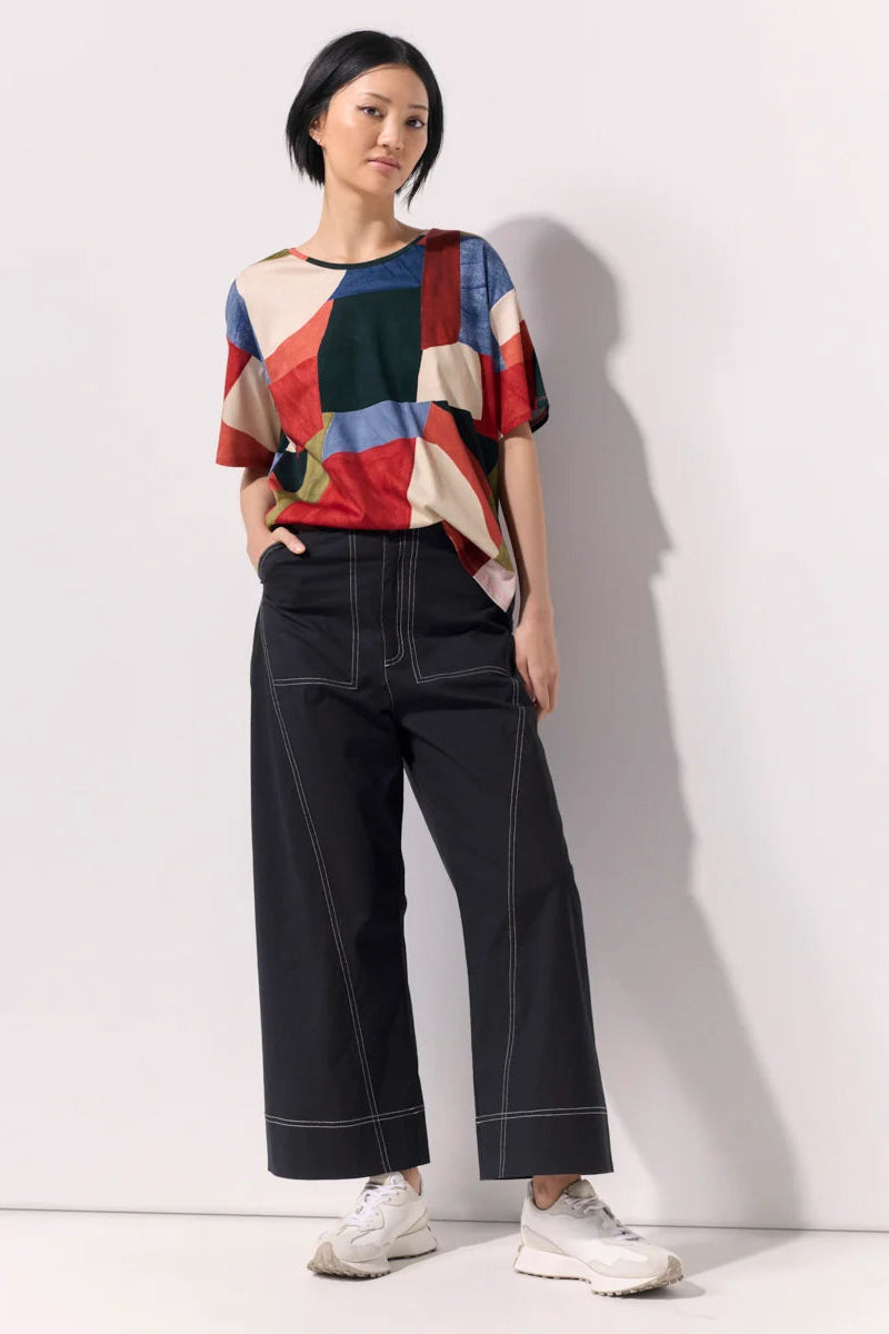 Model wearing an abstract print tee shirt against a white background.