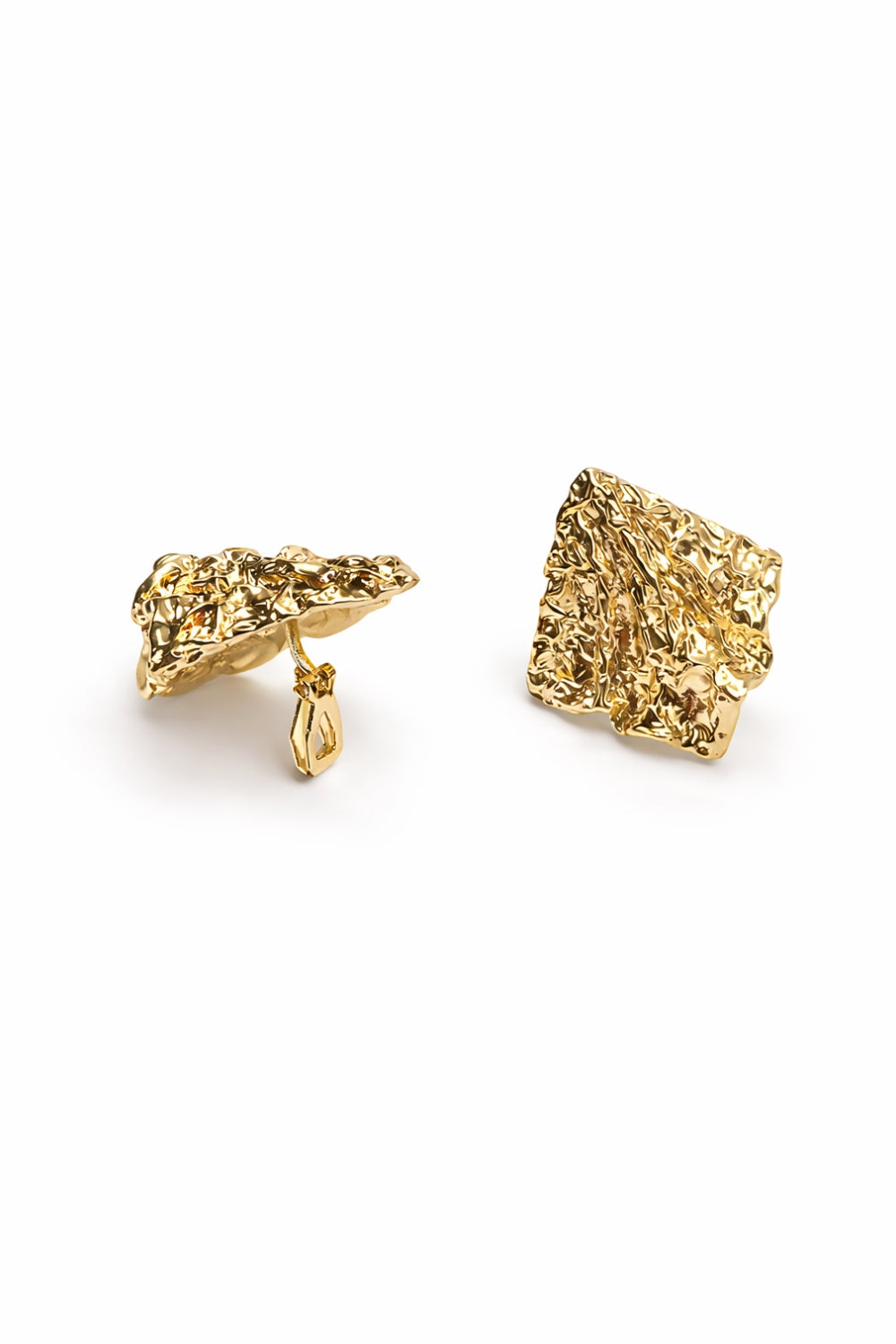Gold textured earrings on a white background