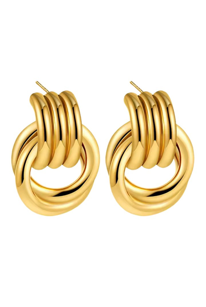 Gold loop drop hoop earrings on a white background