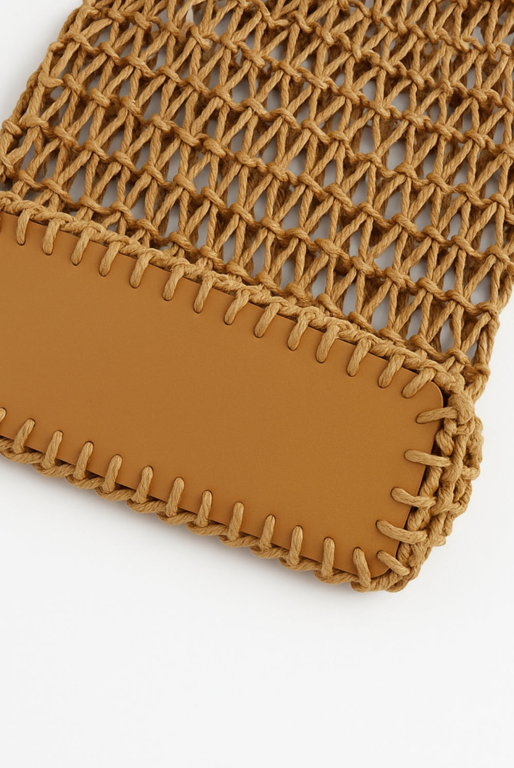 Close-up of a brown woven pouch with a plain background