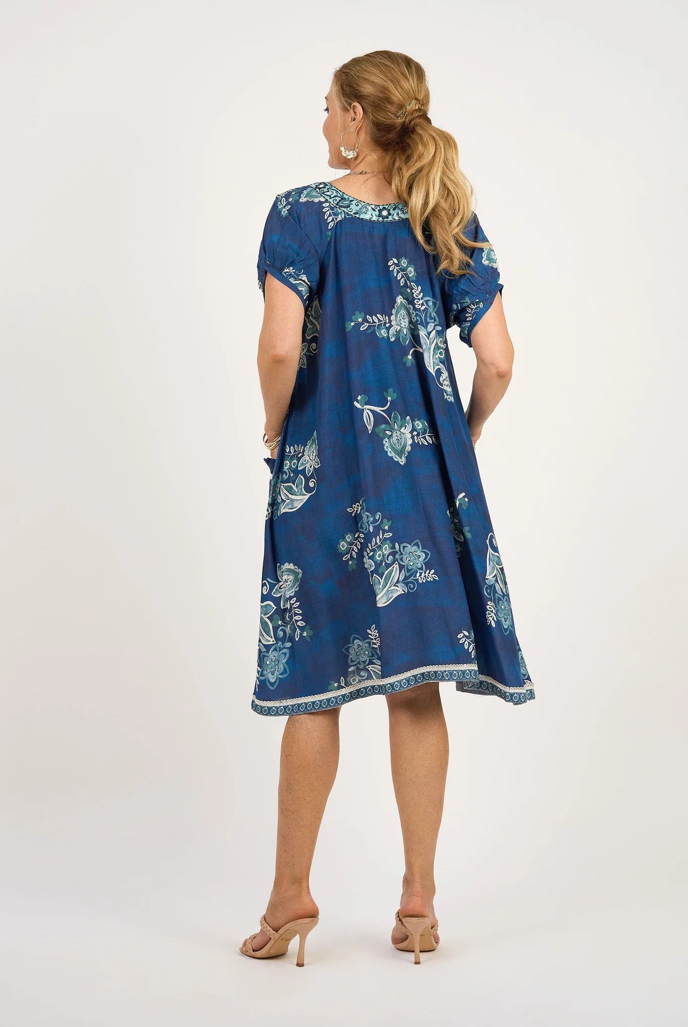 midi dress blue print with tassle tie neck worn by model back view