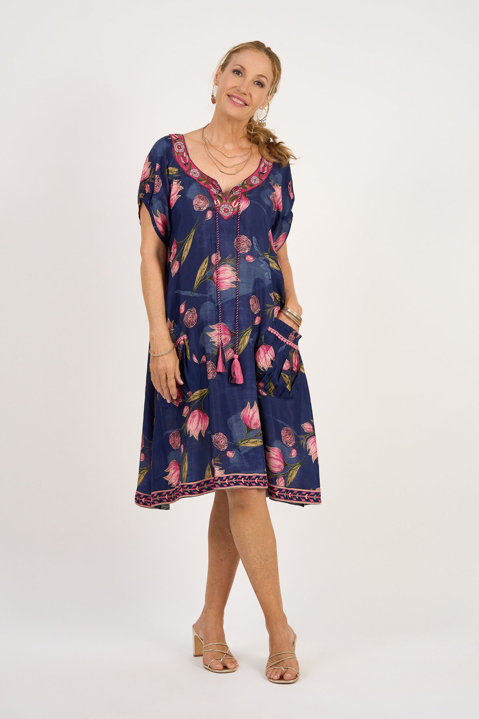 Woman wearing a blue floral dress on a white background