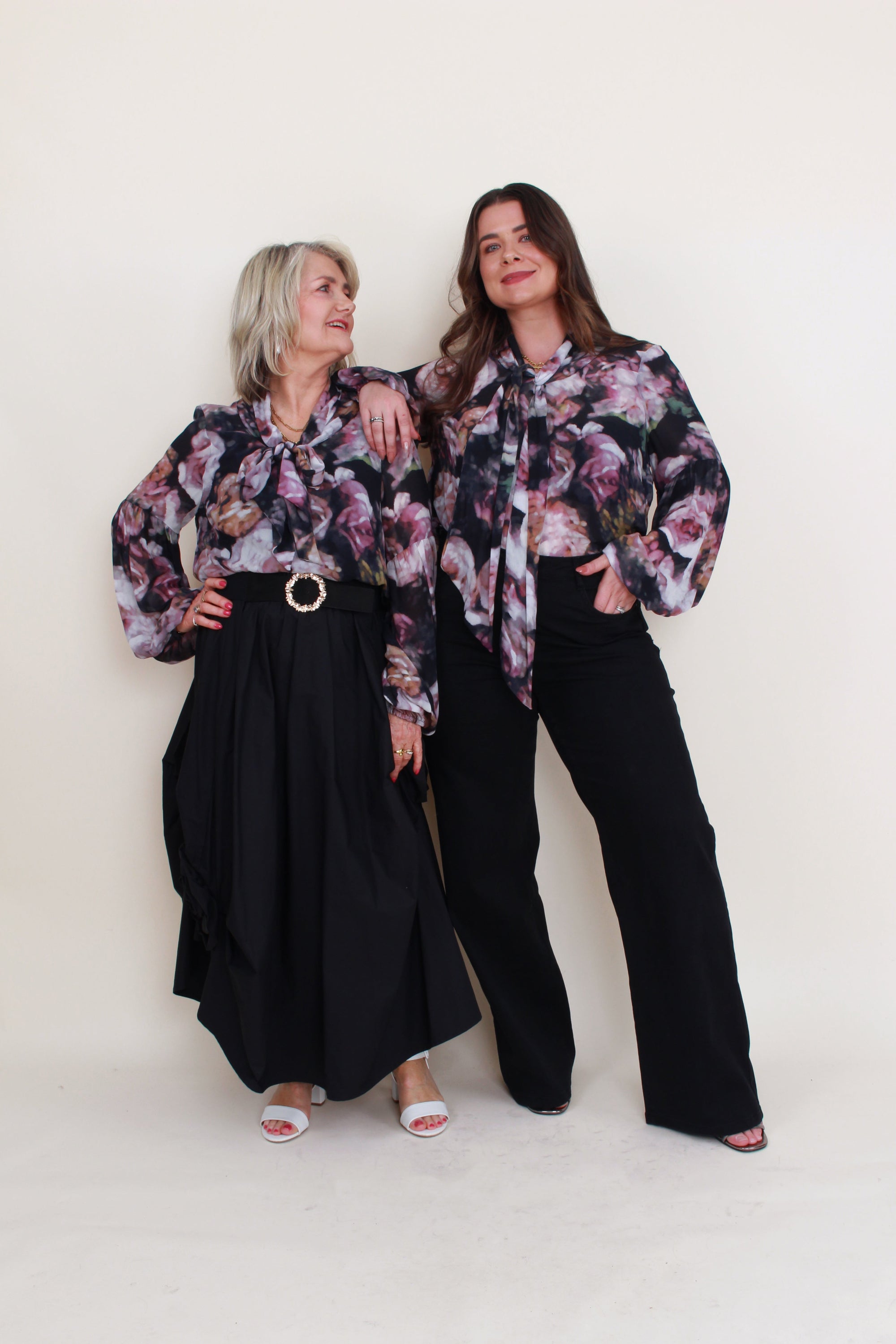 womens floral blouse with neck tie worn by 2 models