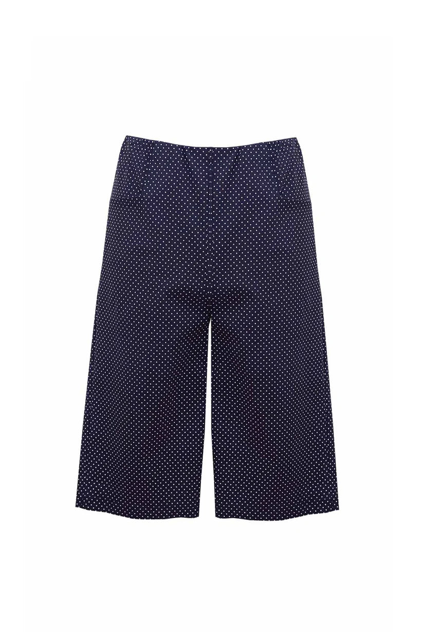 Navy blue pants with white polka dots on a white background