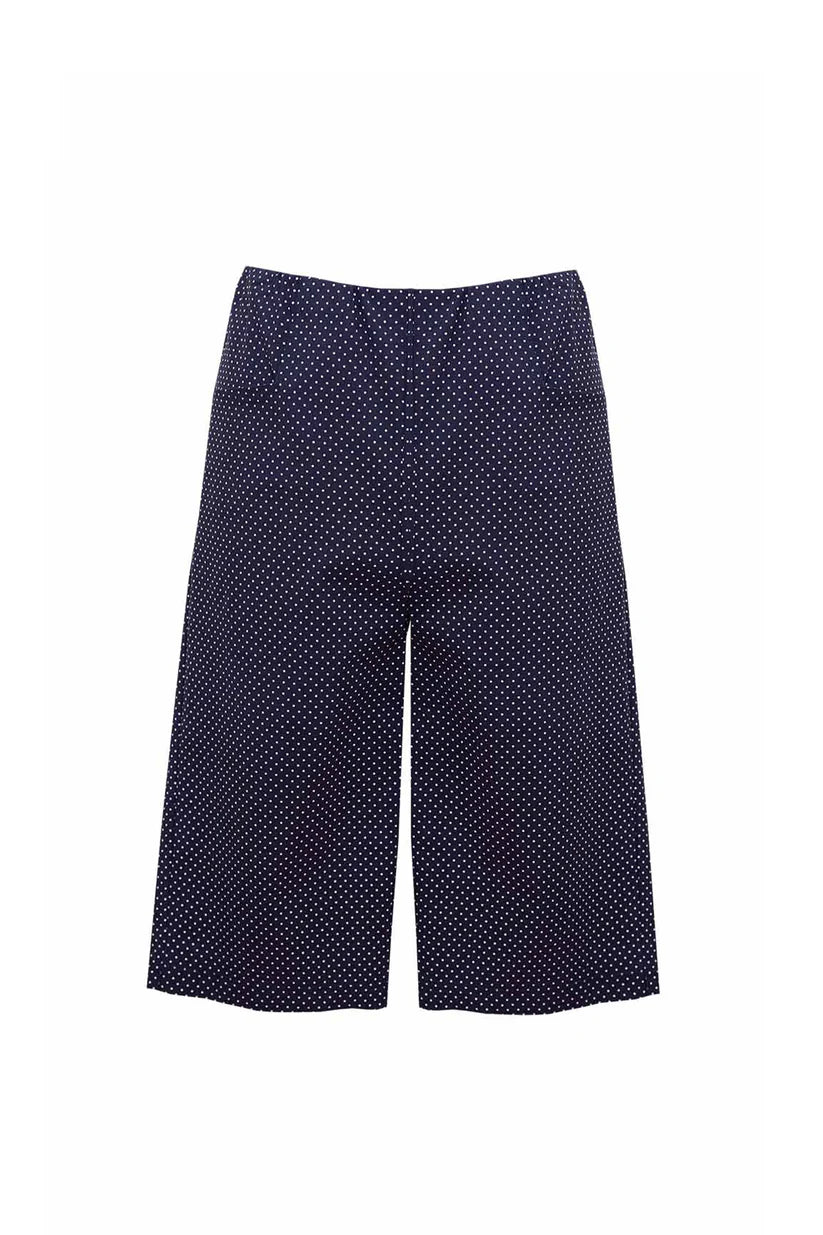 Navy blue pants with white polka dots on a white background