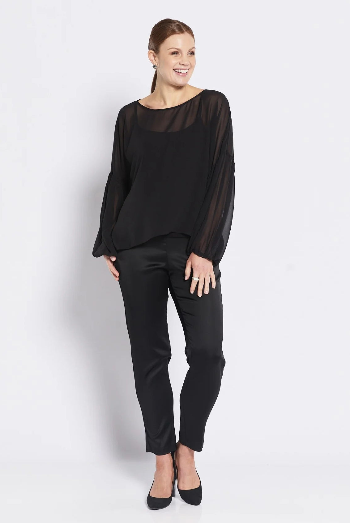 Woman wearing a black outfit on a white background