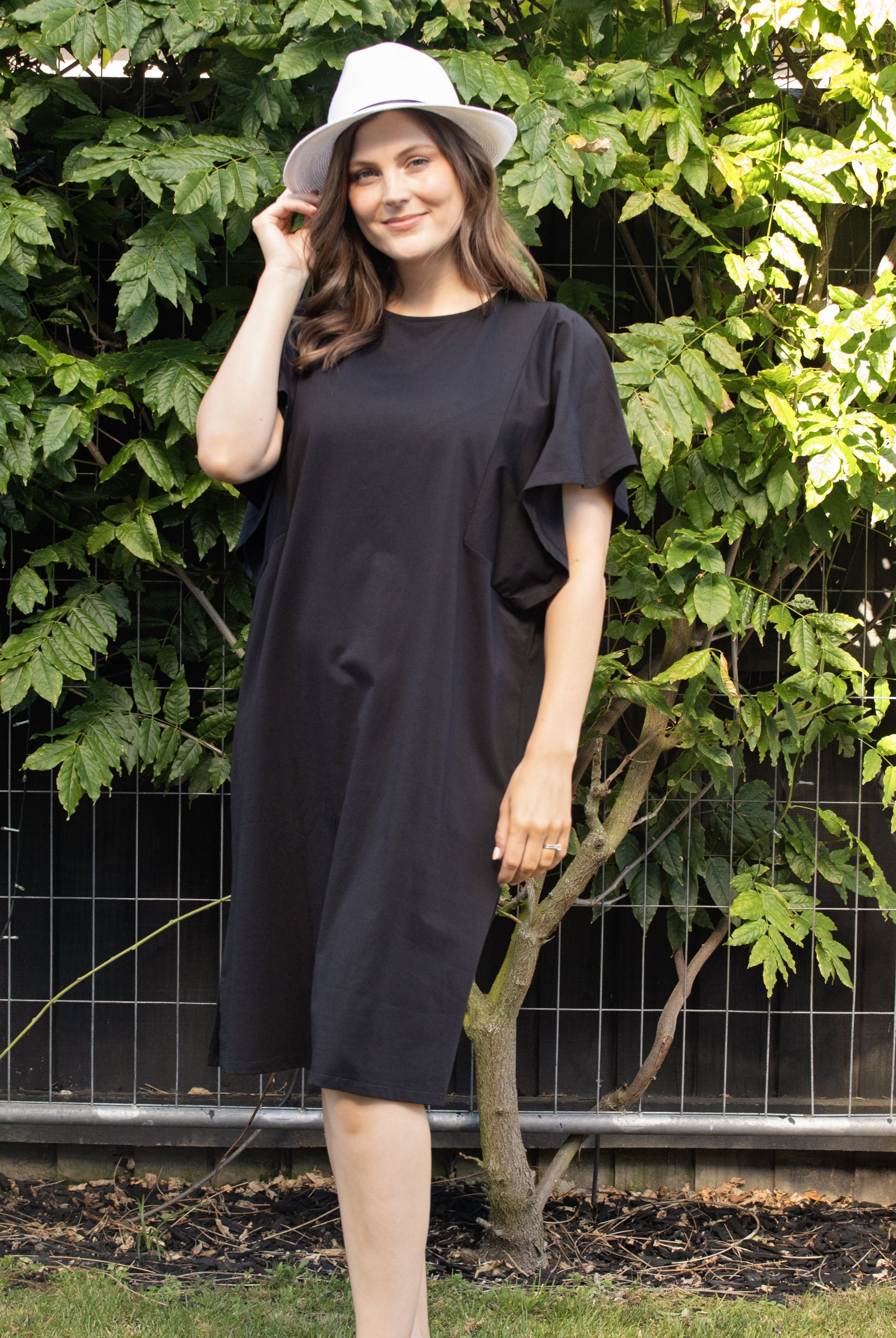 womens kne length midi black dress with flutter sleeves worn by model