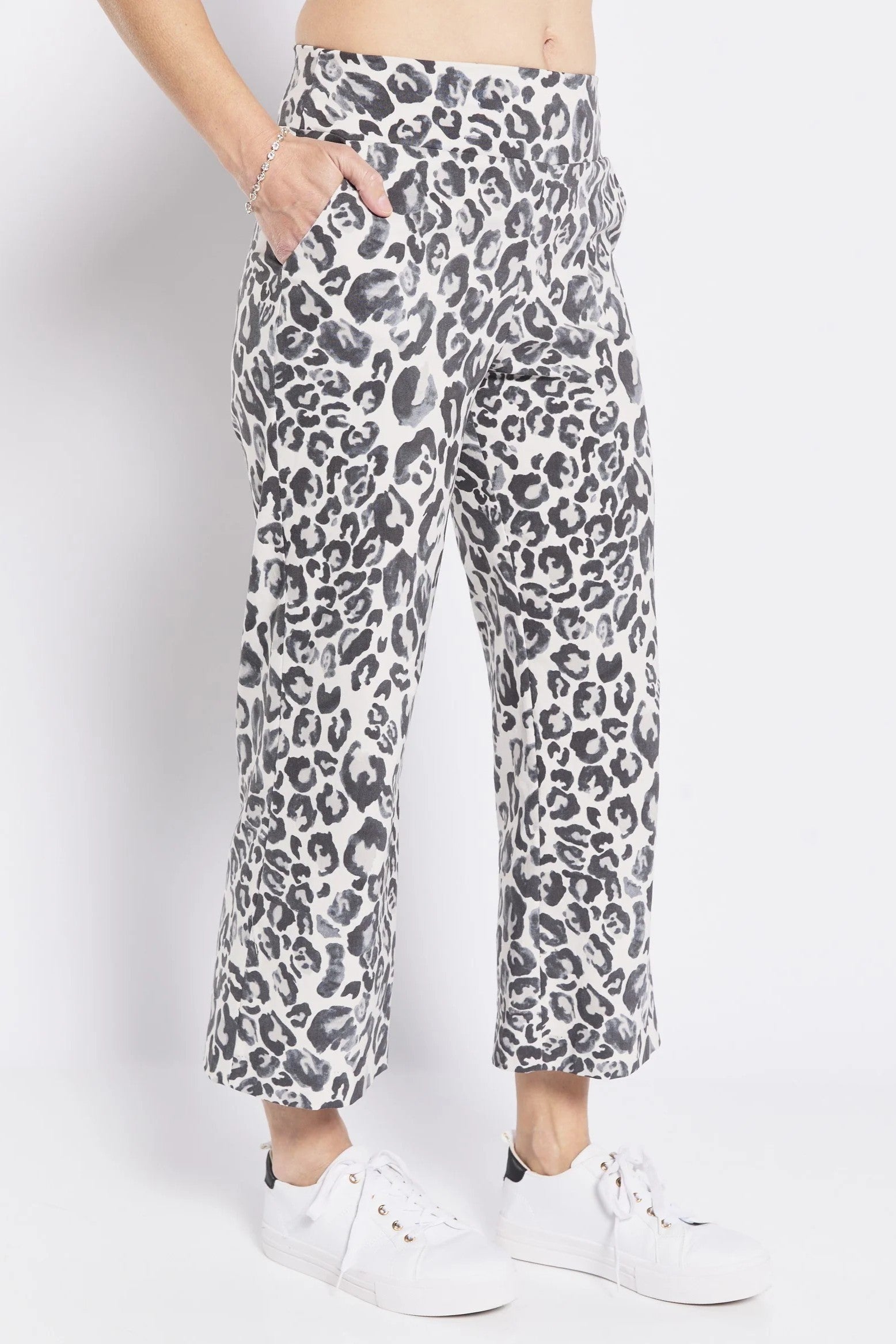 grey leopard print pants worn by a person on a white background