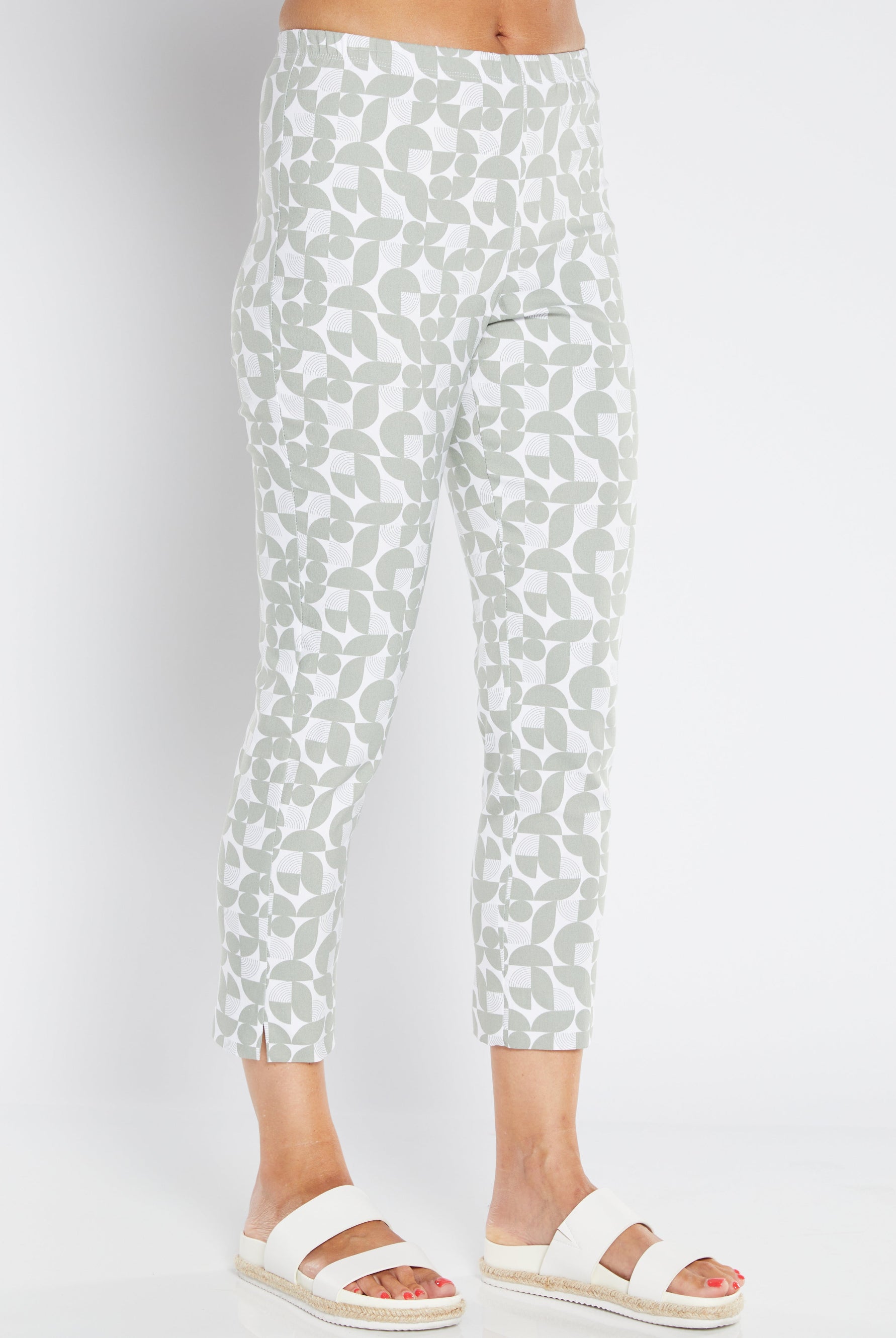 White pants with a subtle greenpattern worn by a person on a white background