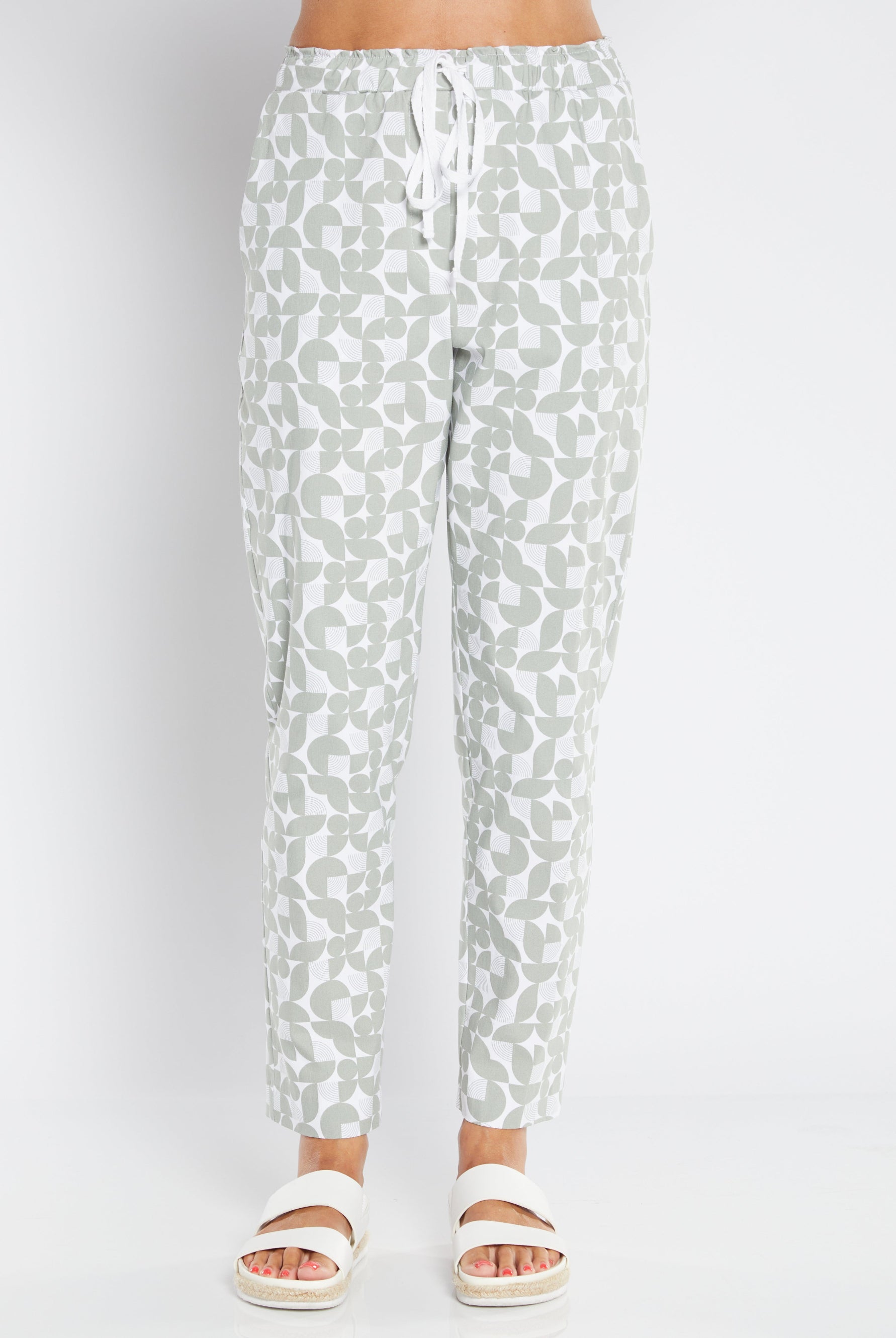 sage green and white pants on plain background