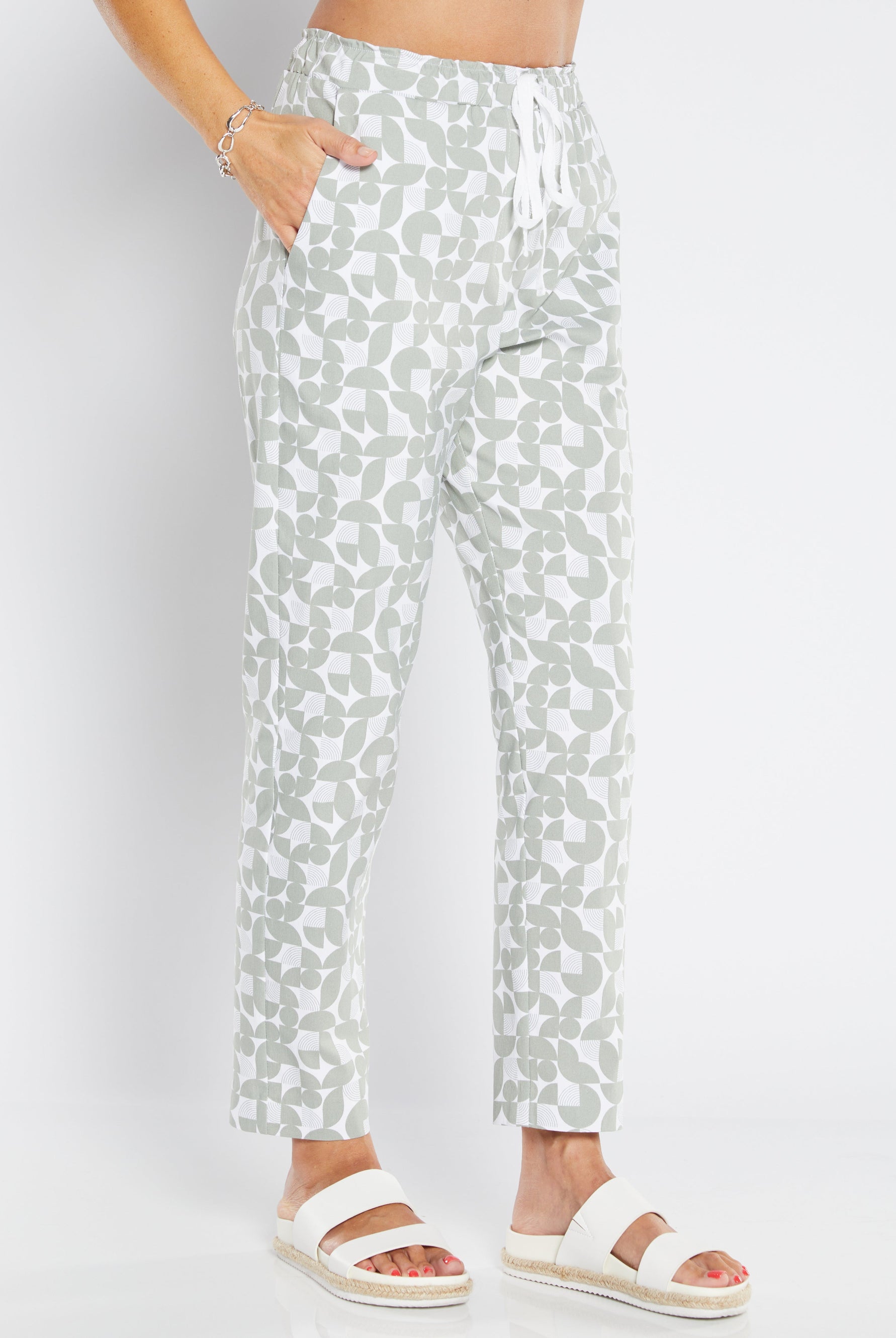 Person wearing light-colored pants with a subtle pattern on a white background