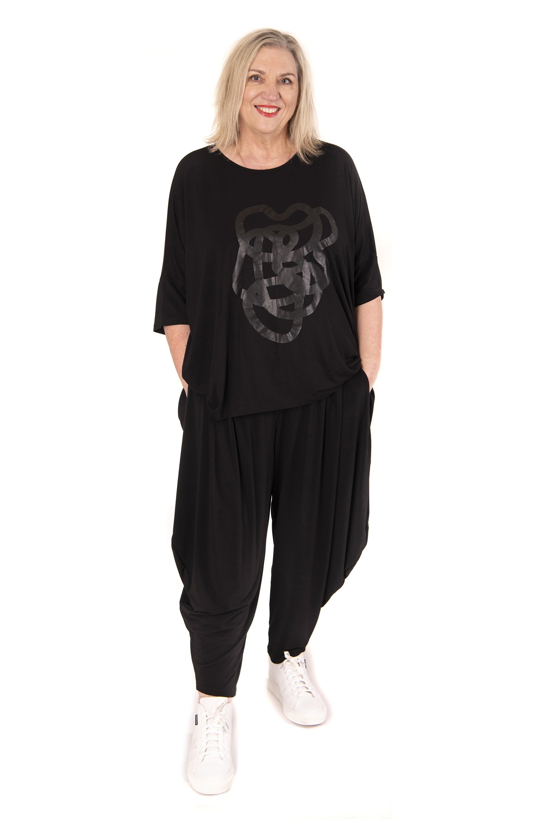 Woman wearing a black outfit with a graphic design on a white background