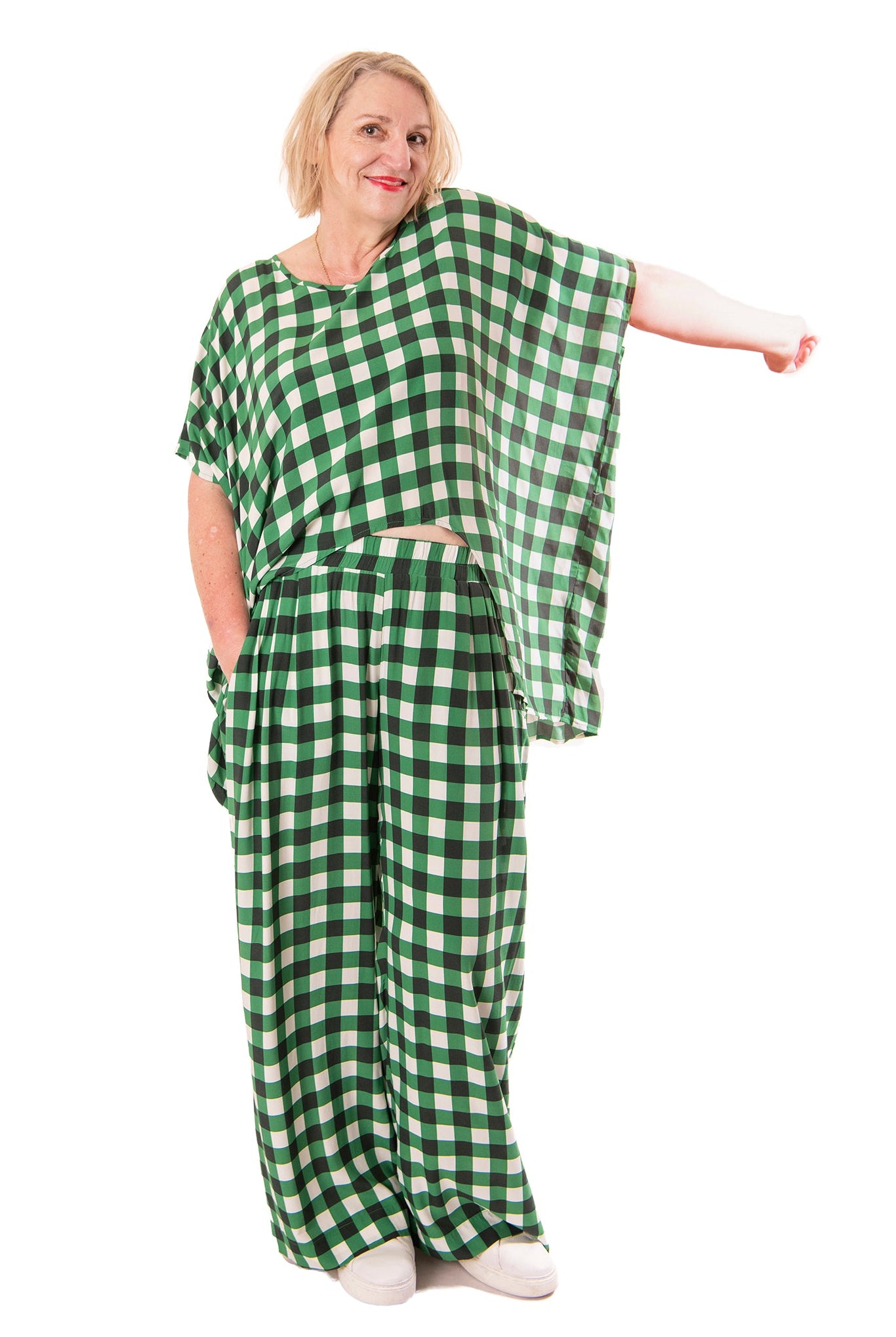 Person wearing a green and white checkered outfit on a white background