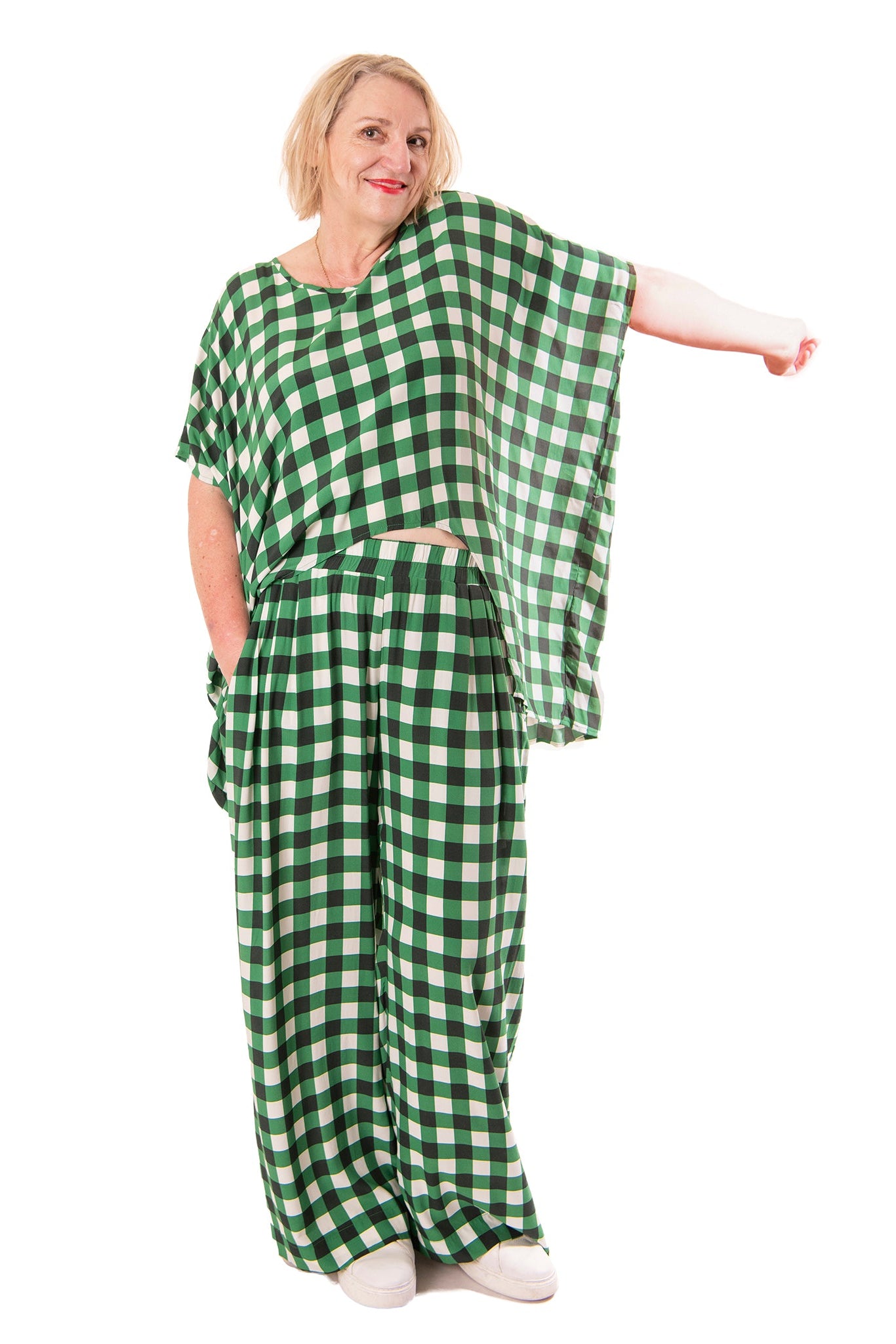 Person wearing a green and white checkered outfit on a white background