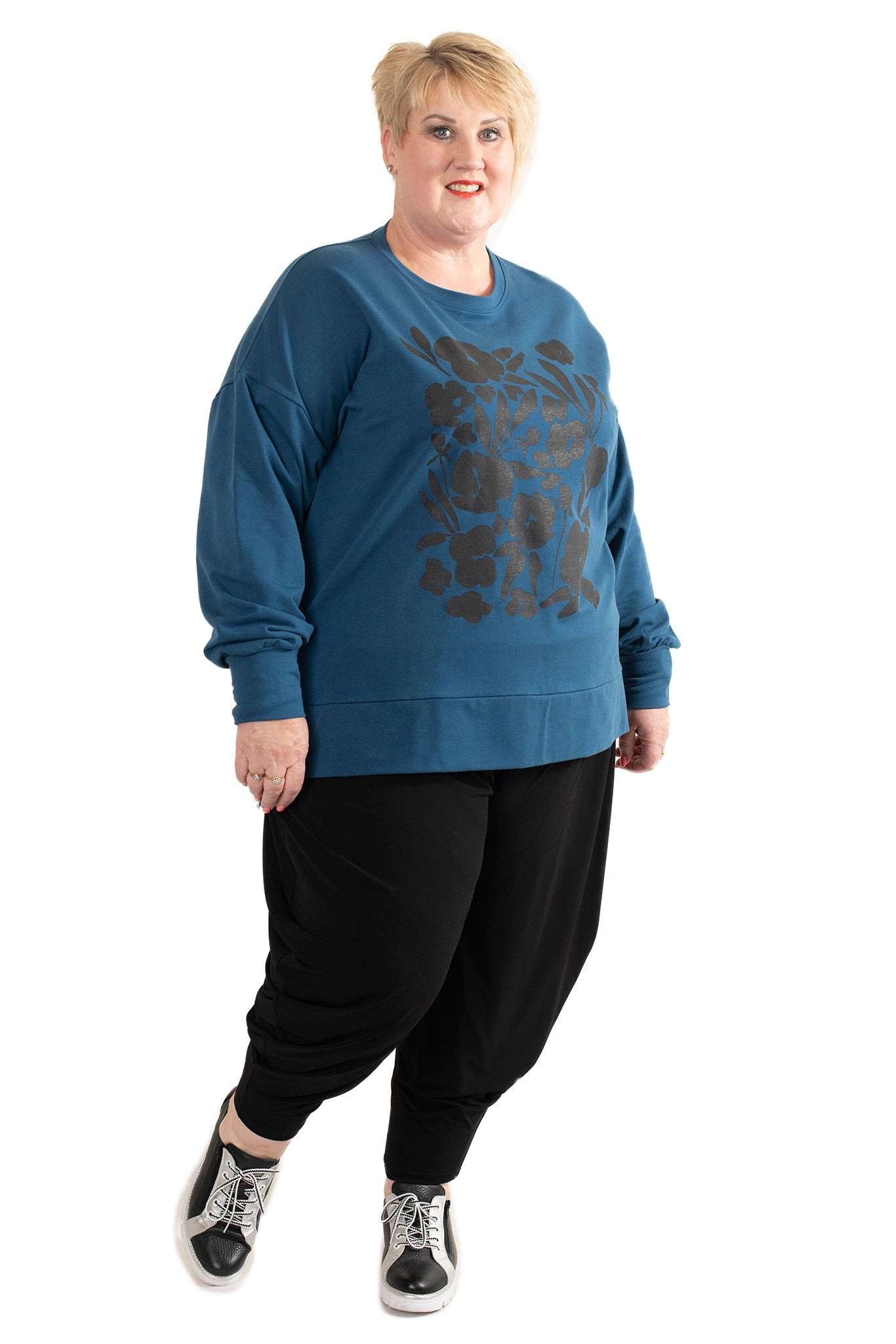 Person wearing a blue sweatshirt with a graphic design on a white background