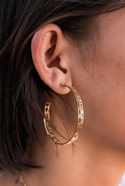 gold hoops earrings with map and clock details on ear