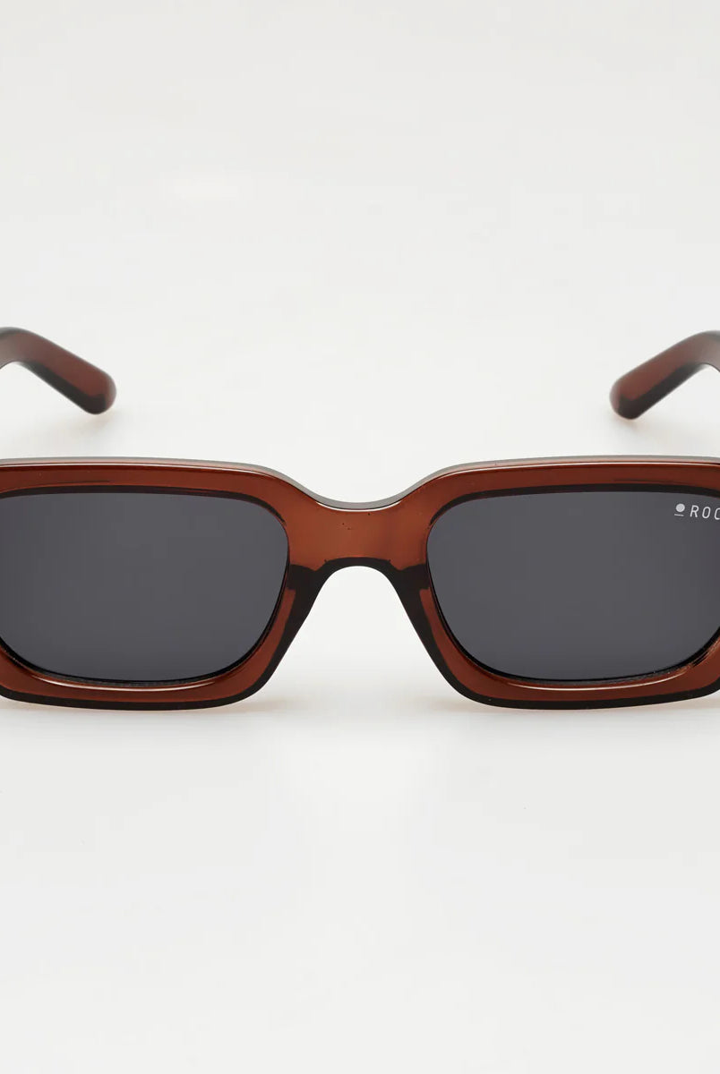 Sunglasses with brown frame and dark lenses on a white background