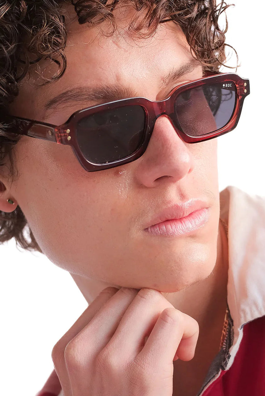 Person wearing sunglasses with a neutral background