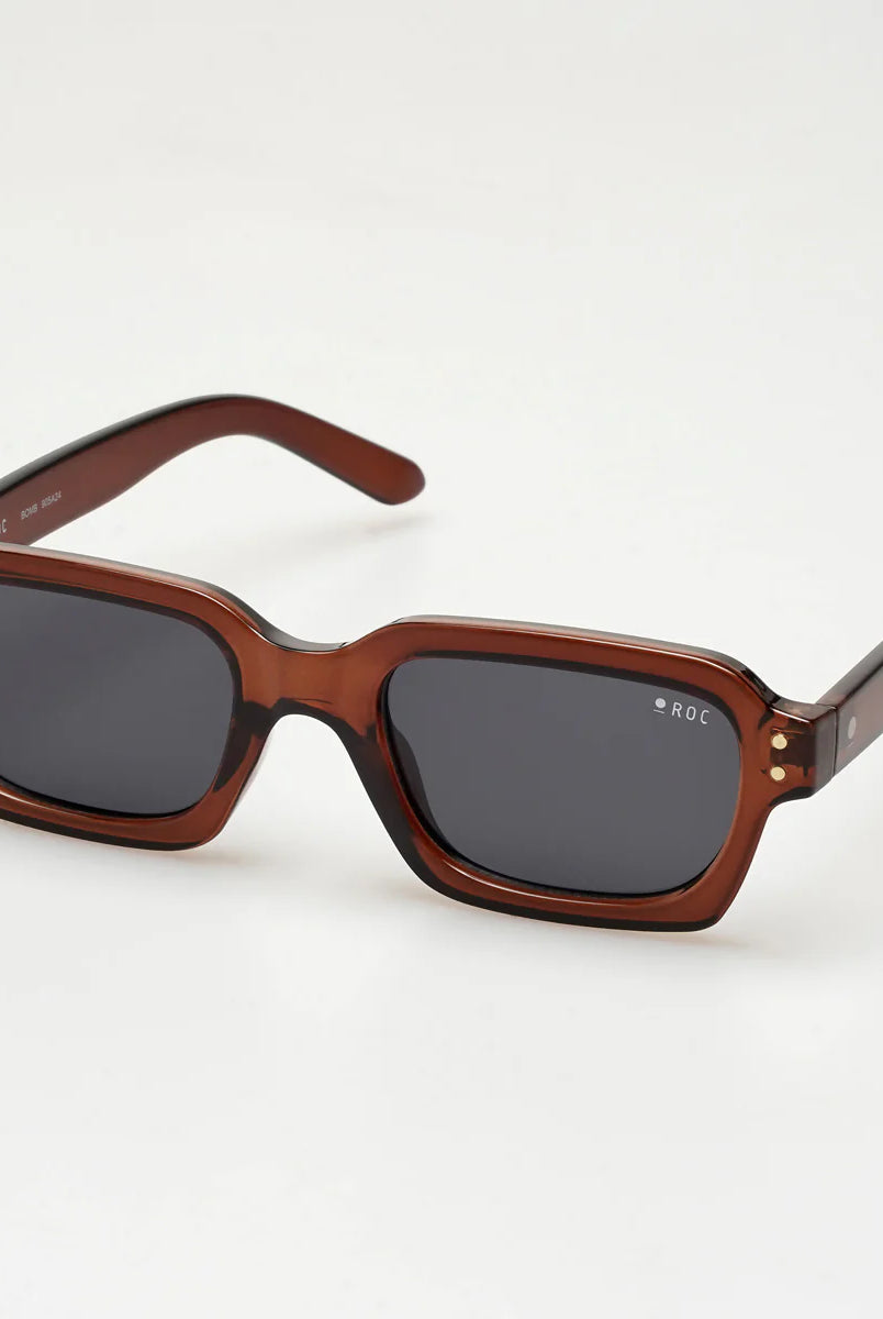 Brown sunglasses with dark lenses on a white background
